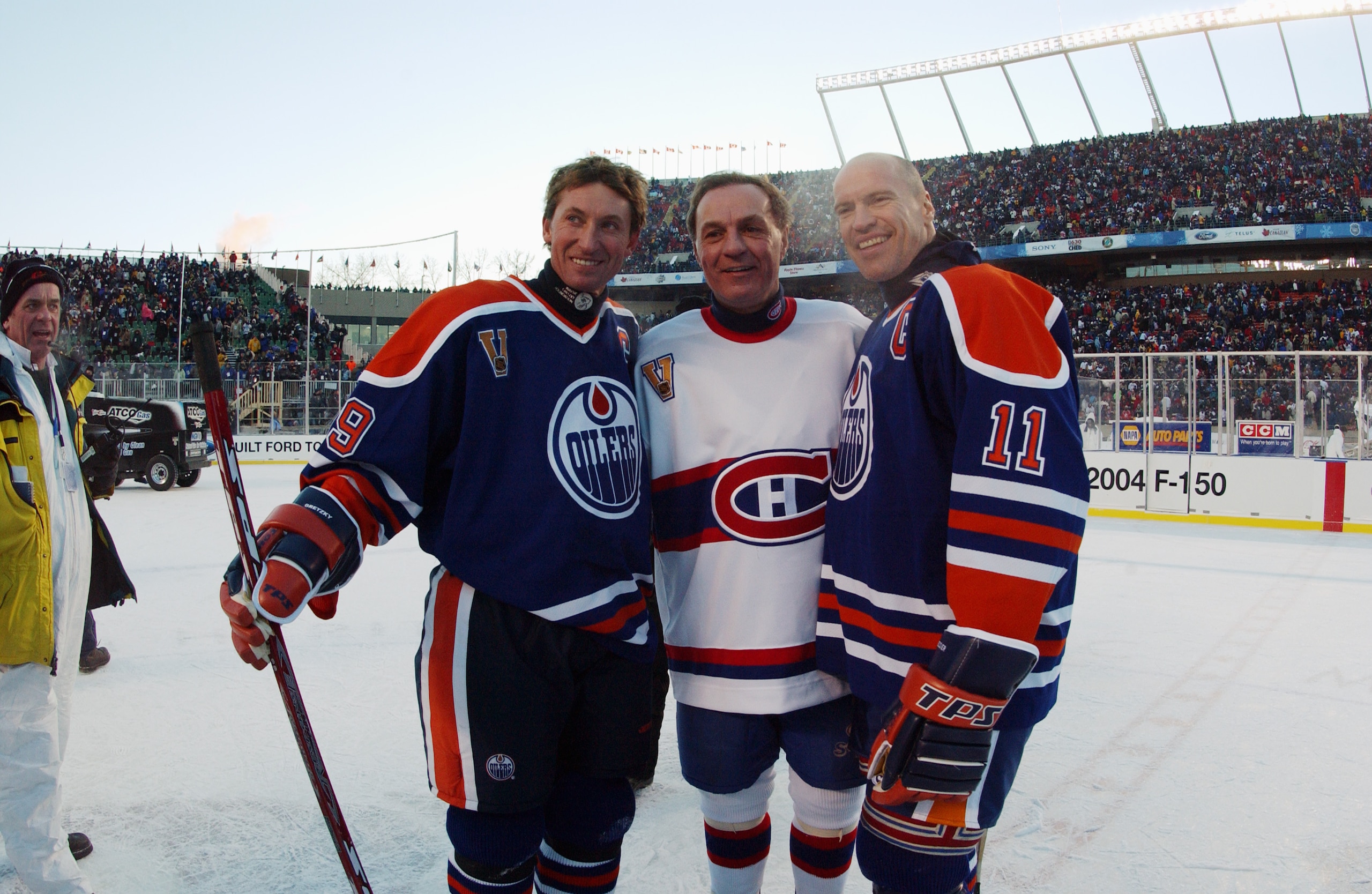 EDMONTON, CANADA - NOVEMBER 22:  Wayne Gretzky #99 of the Edmonton Oilers and teammate Mark Messier #11 pose for a photo with Guy Lafleur #10 of the Montreal Canadiens during the Molson Canadien Heritage Classic on November 22, 2003 at Commonwealth Stadiu