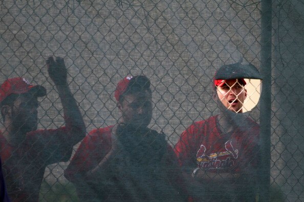 JUPITER, FL - FEBRUARY 16: Pitcher Adam Wainwright #50 of the St. Louis Cardinals peaks through the fence during spring training at Roger Dean Stadium on February 16, 2011 in Jupiter, Florida.  (Photo by Marc Serota/Getty Images)