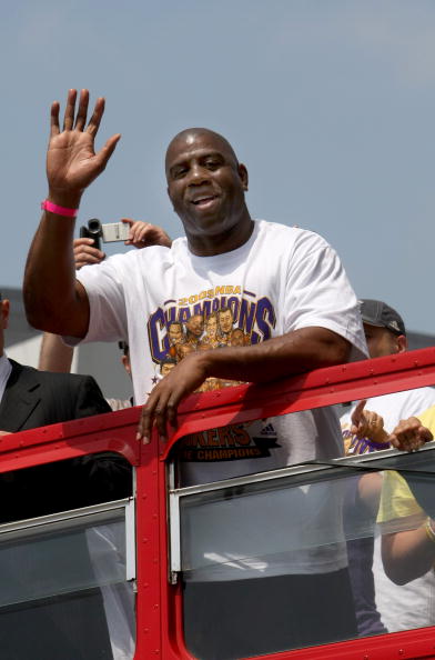 LOS ANGELES, CA - JUNE 17:  Los Angeles Lakers Hall of Fame player and team executive Magic Johnson waves to the crowd from the top of a double decker bus at the start of Los Angeles Lakers NBA championship victory parade outside the Staples Center on Jun