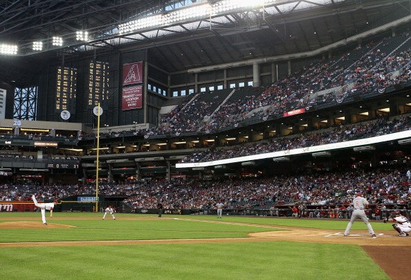 PHOENIX, AZ - APRIL 08:  Starting pitcher Ian Kennedy #31 of the Arizona Diamondbacks throws the first pitch during the Major League Baseball home opening game against the Cincinnati Reds at Chase Field on April 8, 2011 in Phoenix, Arizona.  (Photo by Chr