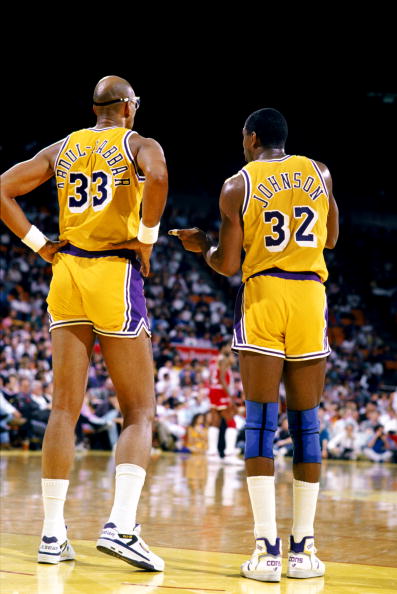 LOS ANGELES - 1988:  Kareem Abdul-Jabbar #33 of the Los Angeles Lakers listens to Magic Johnson #32 during an NBA game at the Great Western Forum in Los Angeles, California in 1988. (Photo by Mike Powell/Getty Images)