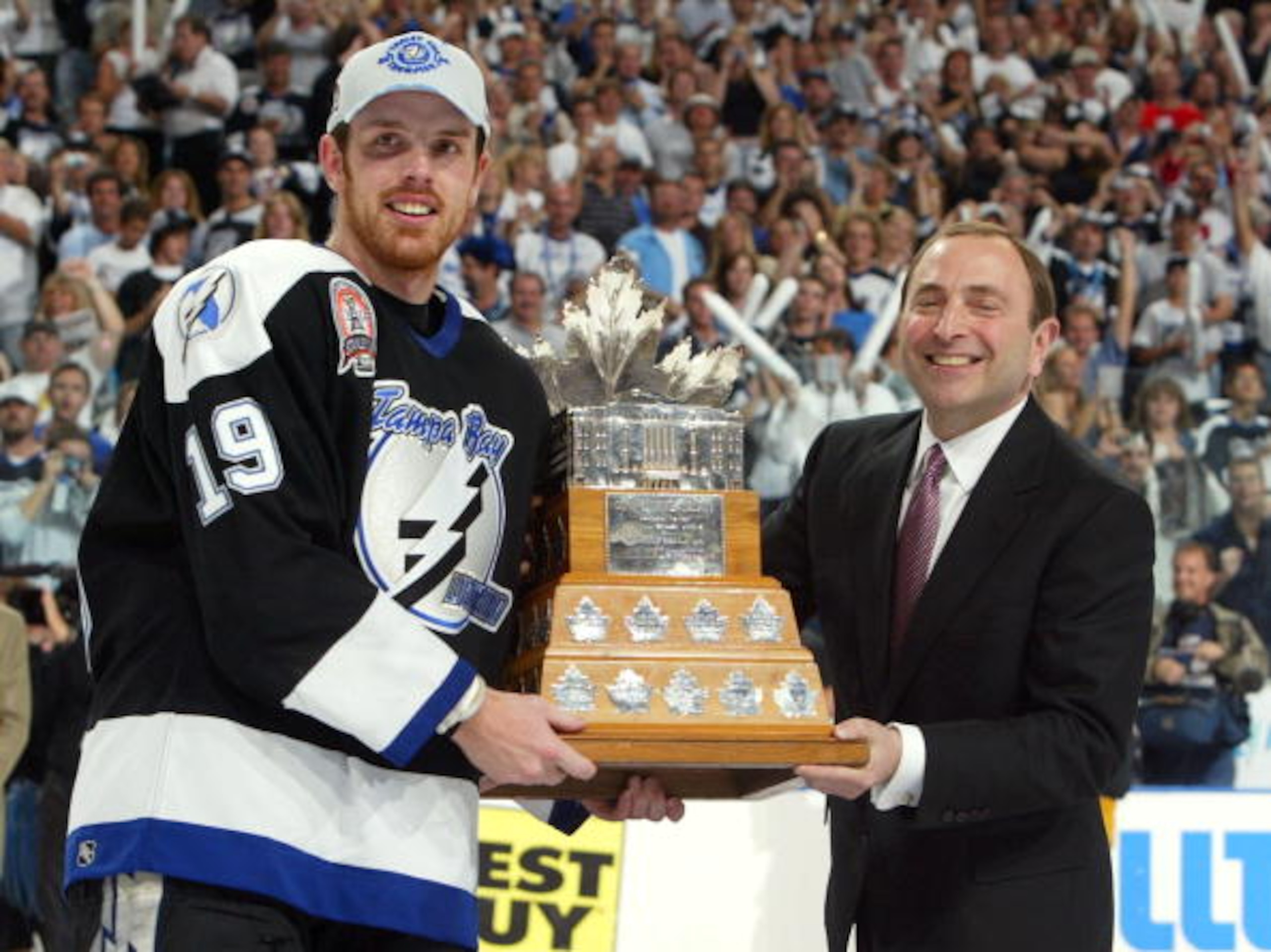 TAMPA, FL - JUNE 7:  Brad Richards #19 of the Tampa Bay Lightning receives the Conn Smythe MVP trophy from NHL Commissioner Gary Bettman after defeating the Calgary Flames 2-1 in game seven of the NHL Stanley Cup Finals on June 7, 2004 at the St. Pete Tim