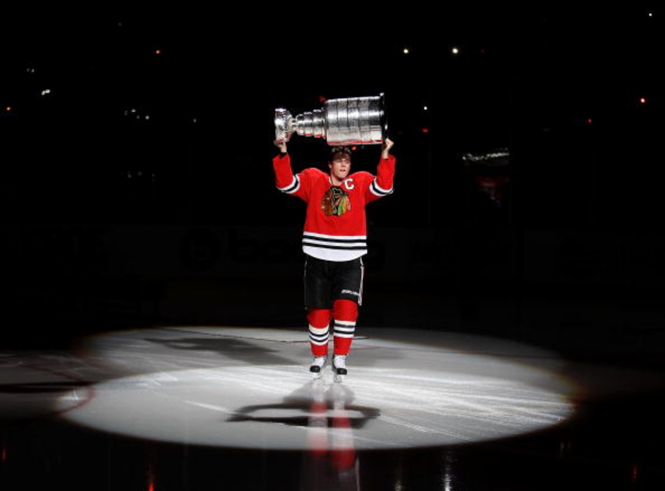 CHICAGO - OCTOBER 09: Jonathan Toews #19 of the Chicago Blackhawks carries the Stanley Cup across the ice in a ceremony before the Blackhawks season home opening game against the Detroit Red Wings at the United Center on October 9, 2010 in Chicago, Illino CHICAGO - OCTOBER 09: Jonathan Toews #19 of the Chicago Blackhawks carries the Stanley Cup across the ice in a ceremony before the Blackhawks season home opening game against the Detroit Red Wings at the United Center on October 9, 2010 in Chicago, Illino