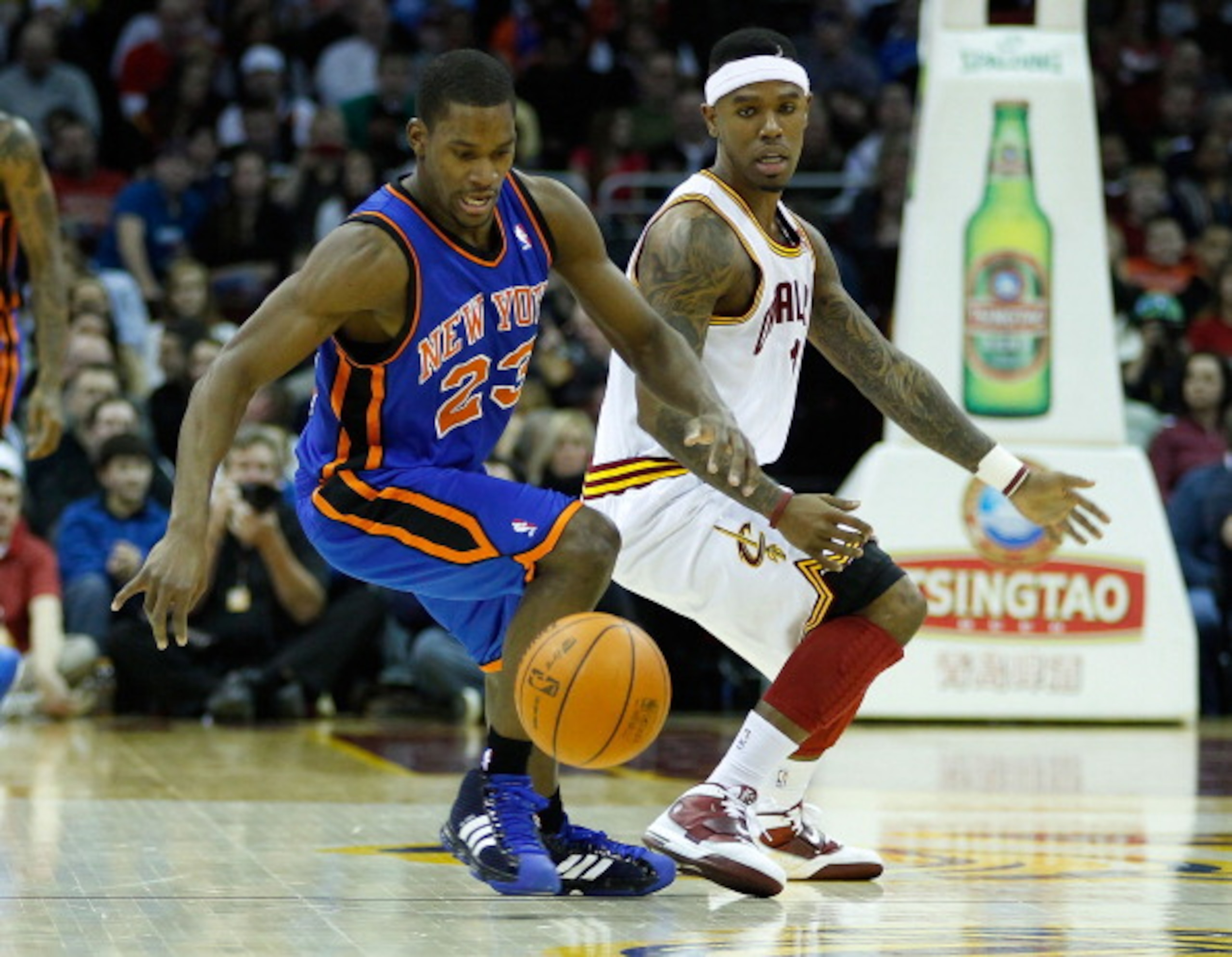CLEVELAND - FEBRUARY 25:  Toney Douglas #23 of the New York Knicks and Daniel Gibson #1 of the Cleveland Cavaliers fight for a loose ball during the game on February 25, 2011 at Quicken Loans Arena in Cleveland, Ohio. NOTE TO USER: User expressly acknowle