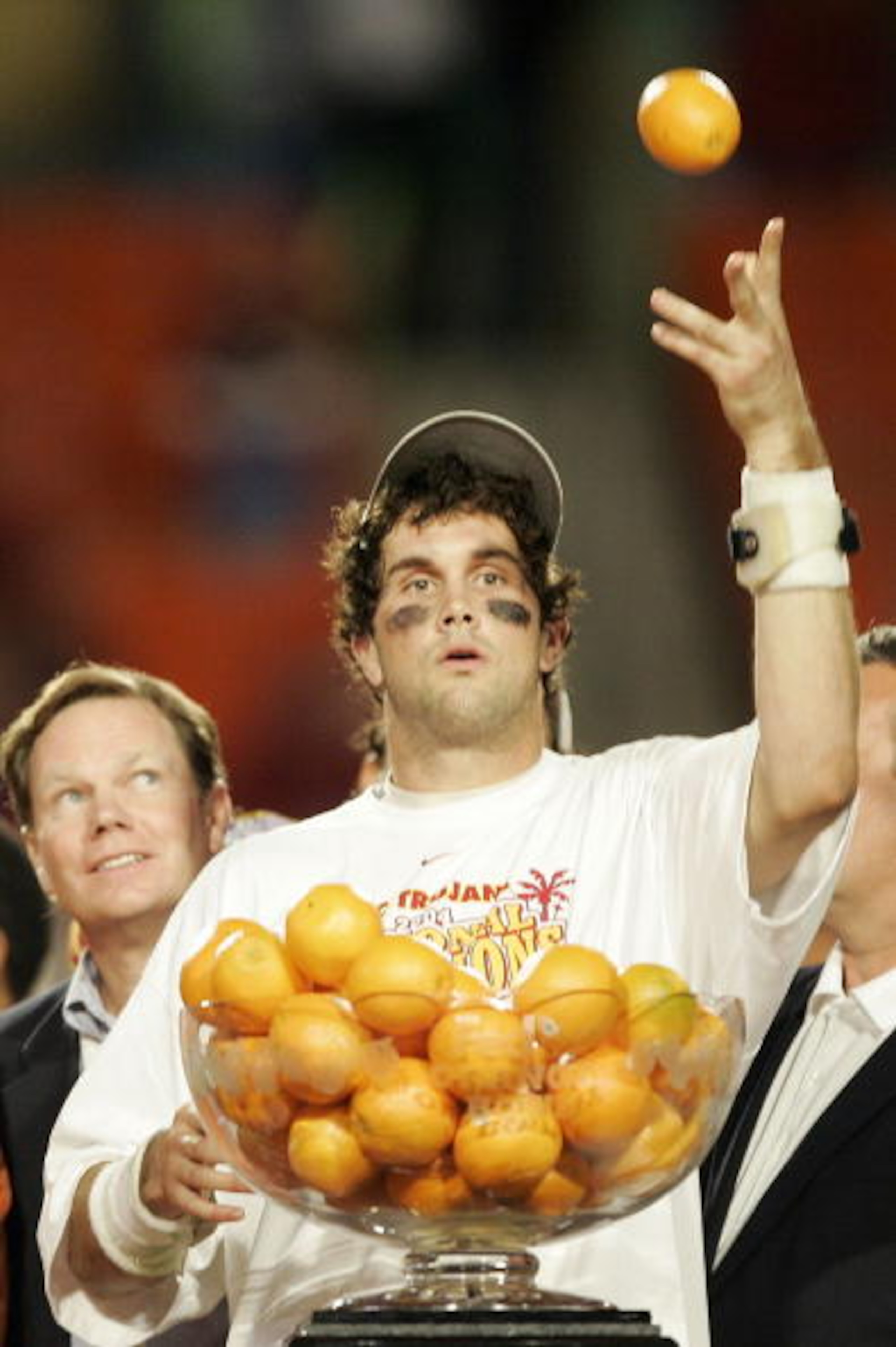 MIAMI - JANUARY 4:  Quarterback Matt Leinart #11 of the USC Trojans celebrates by throwing oranges after defeating the Oklahoma Sooners 55-19 to win the FedEx Orange Bowl 2005 National Championship on January 4, 2005 at Pro Player Stadium in Miami, Florid