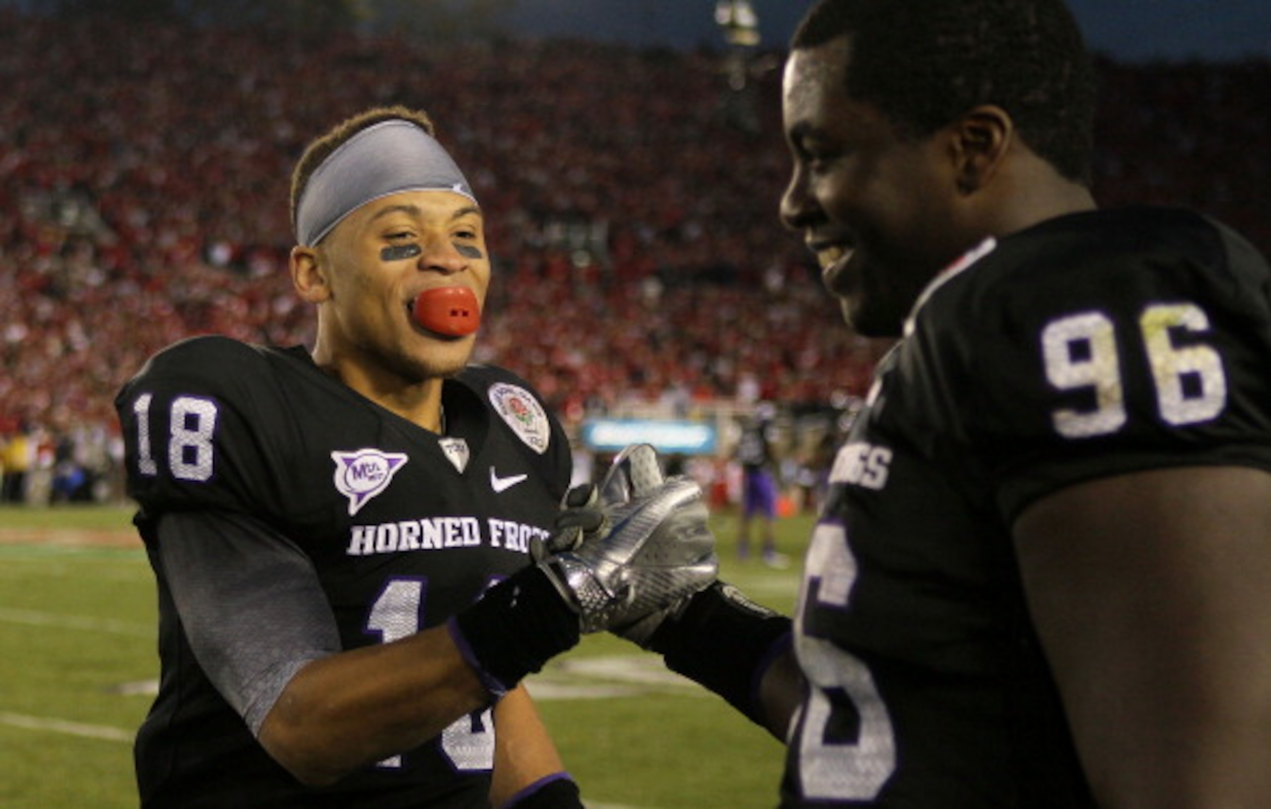 PASADENA, CA - JANUARY 01: Cornerback Travaras Battle #18 of the TCU Horned Frogs celebrates with Wayne Daniels #96 in the final moments of their 21-19 win over the Wisconsin Badgers in the 97th Rose Bowl game on January 1, 2011 in Pasadena, California. PASADENA, CA - JANUARY 01: Cornerback Travaras Battle #18 of the TCU Horned Frogs celebrates with Wayne Daniels #96 in the final moments of their 21-19 win over the Wisconsin Badgers in the 97th Rose Bowl game on January 1, 2011 in Pasadena, California.