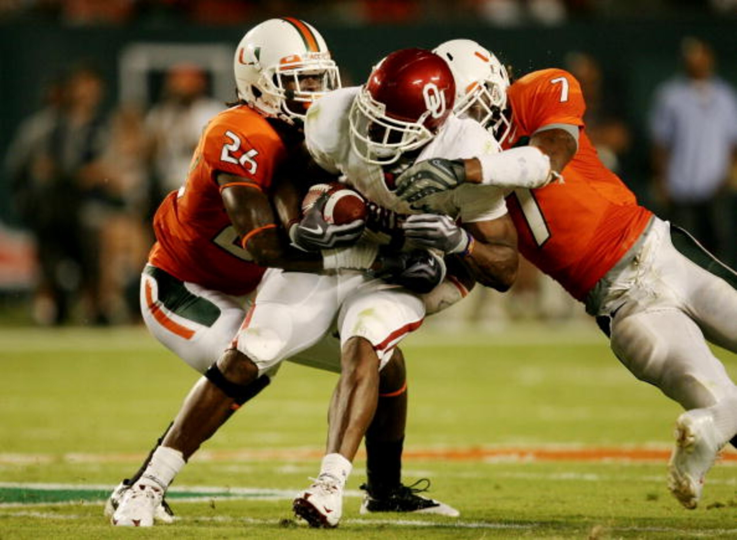 MIAMI GARDENS, FL - OCTOBER 3: DeMarco Murray #7 of the Oklahoma Sooners gets tackled by Ray Ray Armstrong #26 and Vaughn Telemaque #7 of the Miami Hurricanes after getting first down in the second quarter of the game on October 3, 2009 at Landshark Sta MIAMI GARDENS, FL - OCTOBER 3: DeMarco Murray #7 of the Oklahoma Sooners gets tackled by Ray Ray Armstrong #26 and Vaughn Telemaque #7 of the Miami Hurricanes after getting first down in the second quarter of the game on October 3, 2009 at Landshark Sta