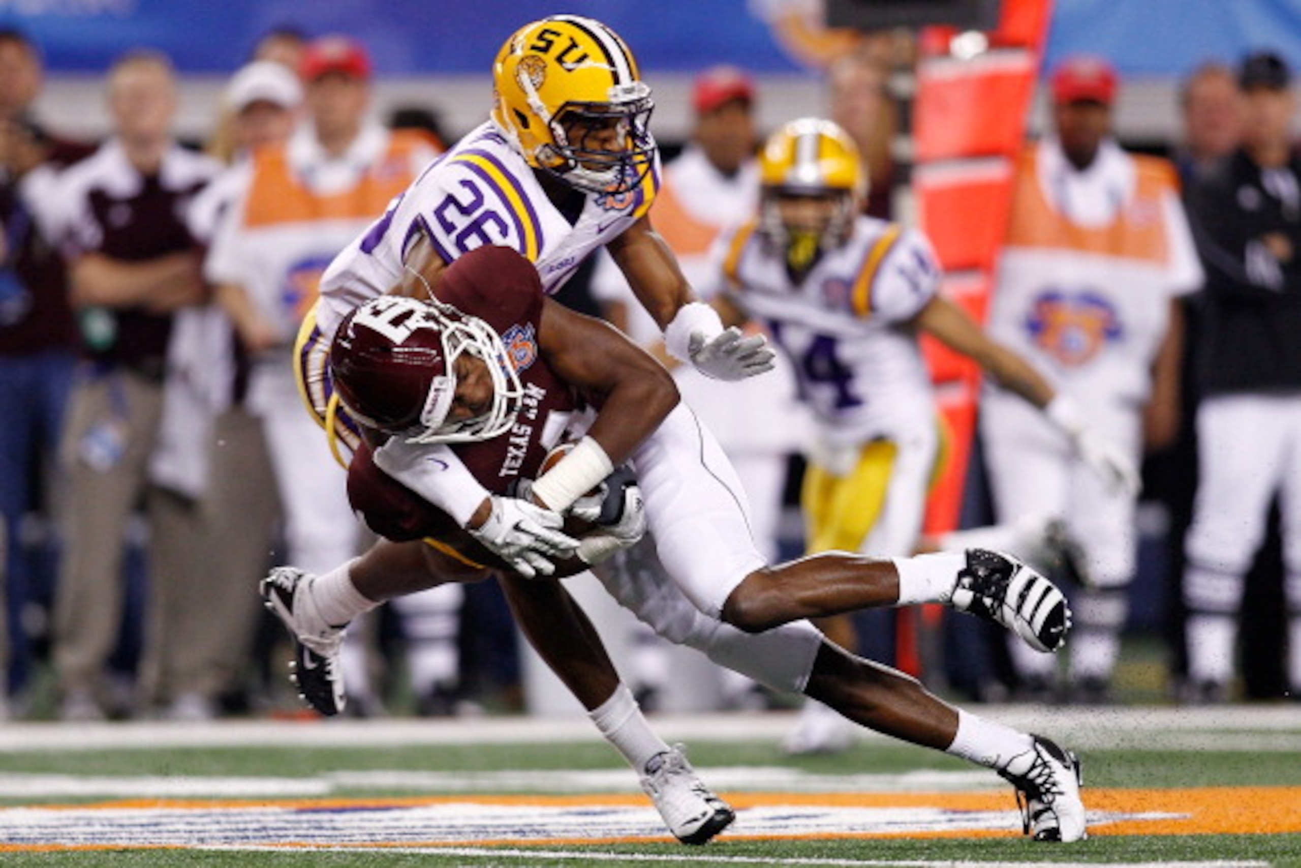 ARLINGTON, TX - JANUARY 07: Brandal Jackson #4 of the Texas A&M Aggies is tackled by Tharold Simon #26 of the Louisiana State University Tigers during the AT&T Cotton Bowl at Cowboys Stadium on January 7, 2011 in Arlington, Texas. (Photo by Chris Grayth ARLINGTON, TX - JANUARY 07: Brandal Jackson #4 of the Texas A&M Aggies is tackled by Tharold Simon #26 of the Louisiana State University Tigers during the AT&T Cotton Bowl at Cowboys Stadium on January 7, 2011 in Arlington, Texas. (Photo by Chris Grayth
