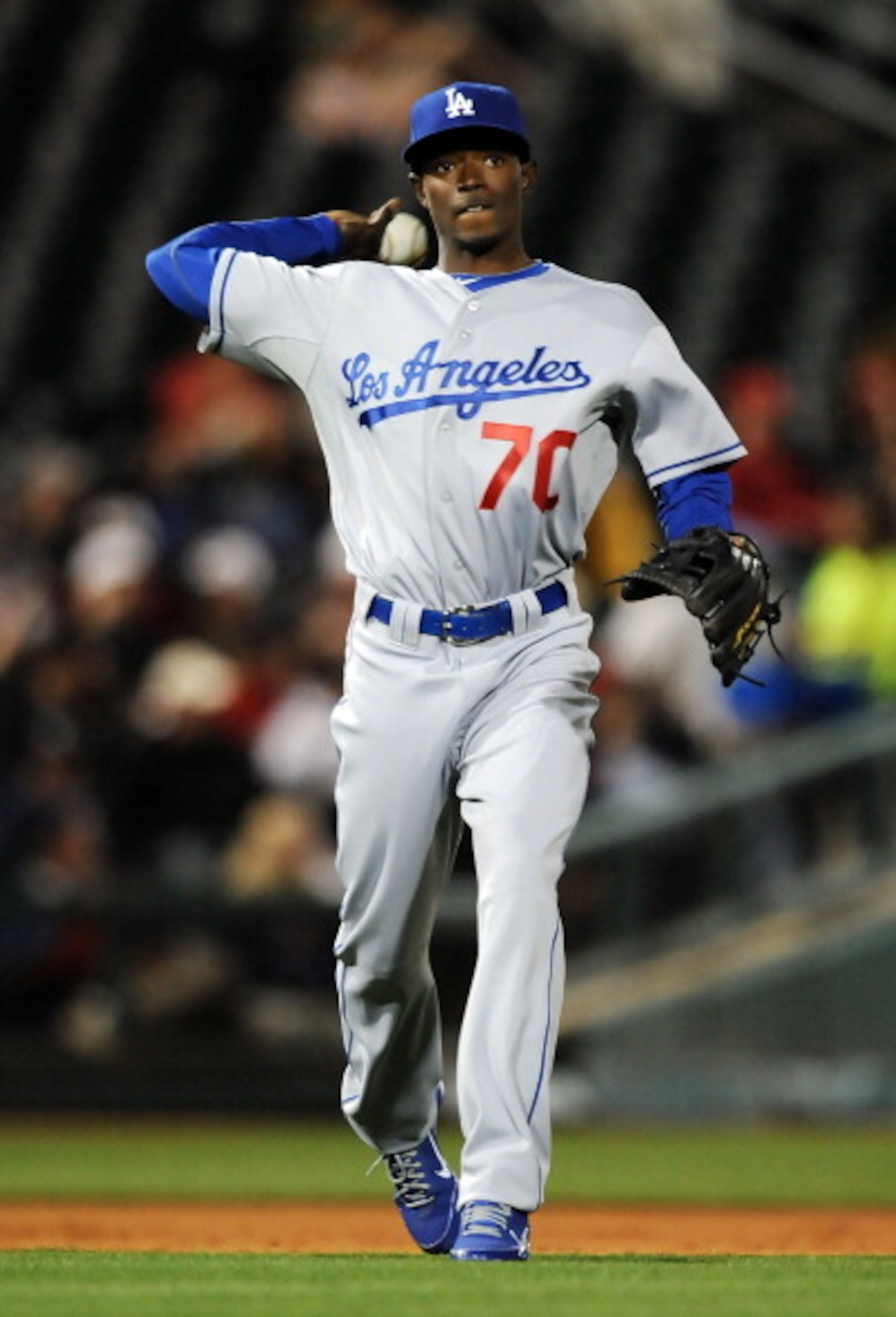 GOODYEAR, AZ - MARCH 03:  Dee Gordon #70 of the Los Angeles Dodgers throws the ball to first base against the Cincinnati Reds at Goodyear Ballpark on March 3, 2011 in Goodyear, Arizona.  (Photo by Norm Hall/Getty Images)