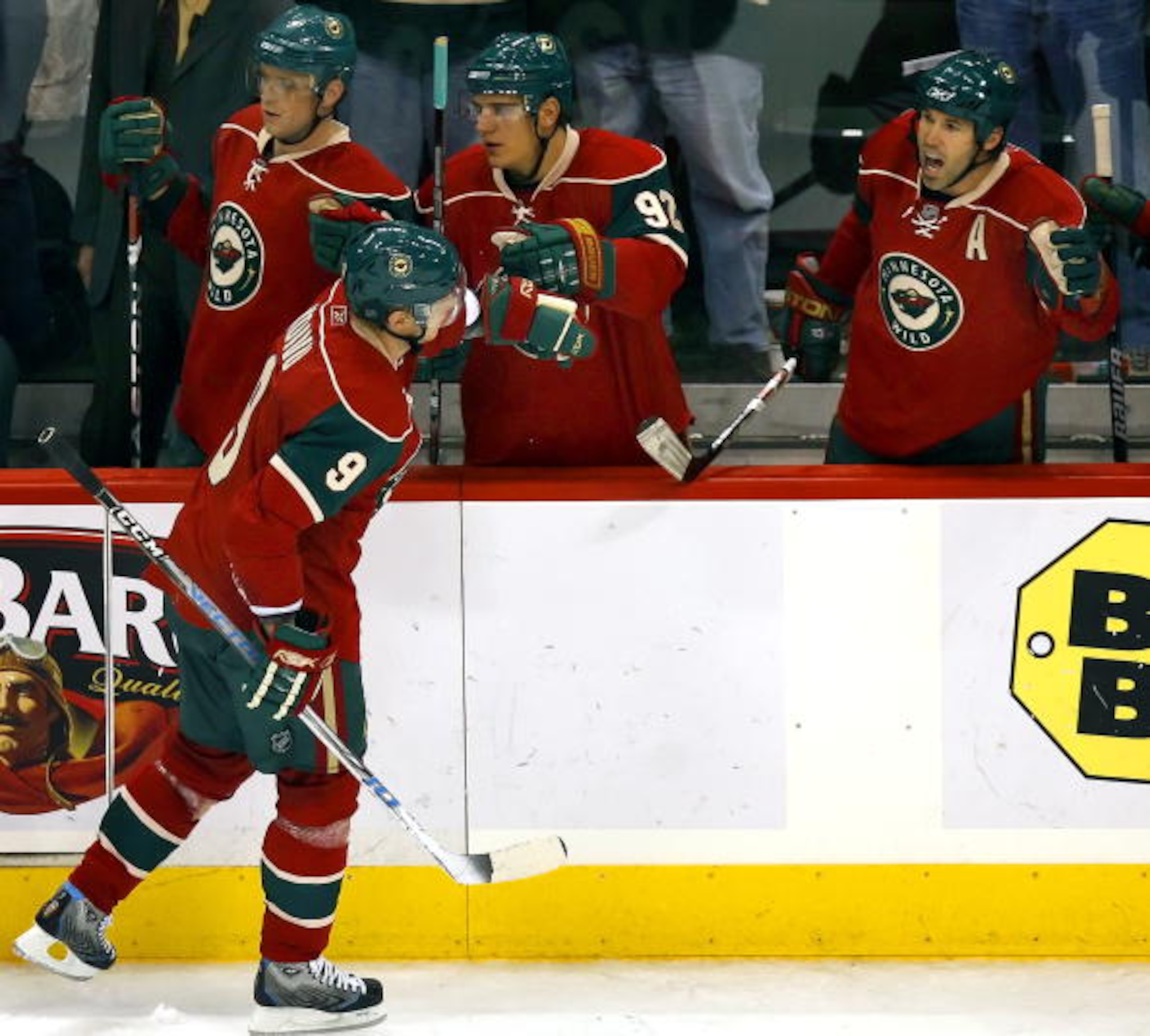 ST. PAUL, MN - OCTOBER 21:  Mikko Koivu #9 of the Minnesota Wild gets high-fives from teammates Marian Gaborik #10, Branko Radivojevic #92 and Brian Rolston #12 after scoring in the third period of their game against the Colorado Avalanche at the Xcel Ene