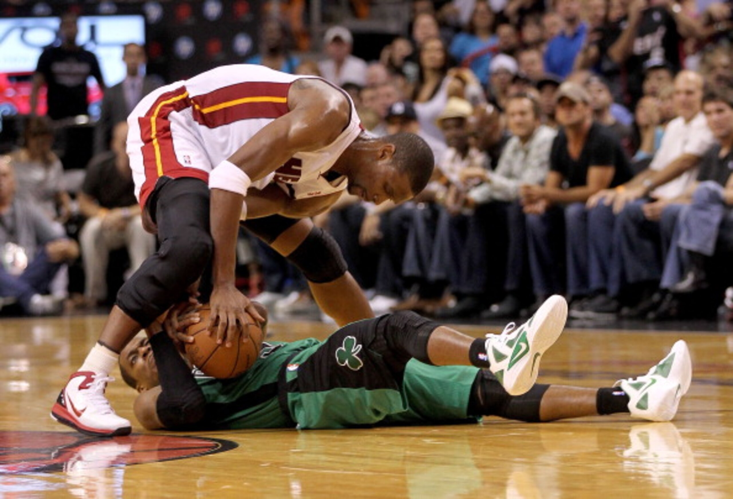 MIAMI, FL - APRIL 10: Chris Bosh #1 of the Miami Heat fights for a loose ball with Rajon Rondo #9 of the Boston Celtics during a game  at American Airlines Arena on April 10, 2011 in Miami, Florida. NOTE TO USER: User expressly acknowledges and agrees tha