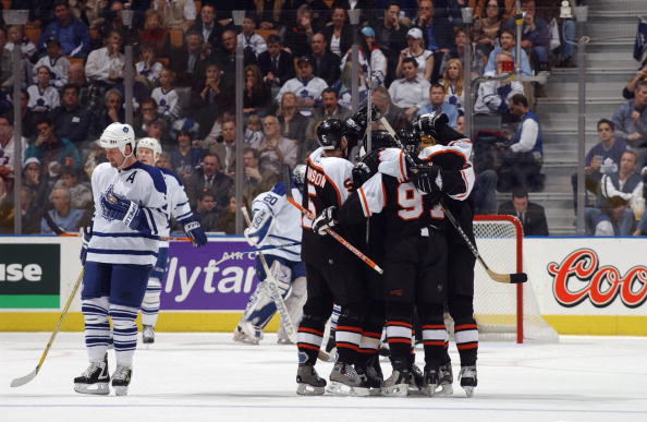 TORONTO - APRIL 21:  Gary Roberts #7 of the Toronto Maple Leafs skates back to center ice as Jeremy Roenick #97 of the Philadelphia Flyers is congratulated by teammates Kim Johnsson #5, Tony Amonte #11, Eric Weinrich #2 and Sami Kapanen #24 after tying th