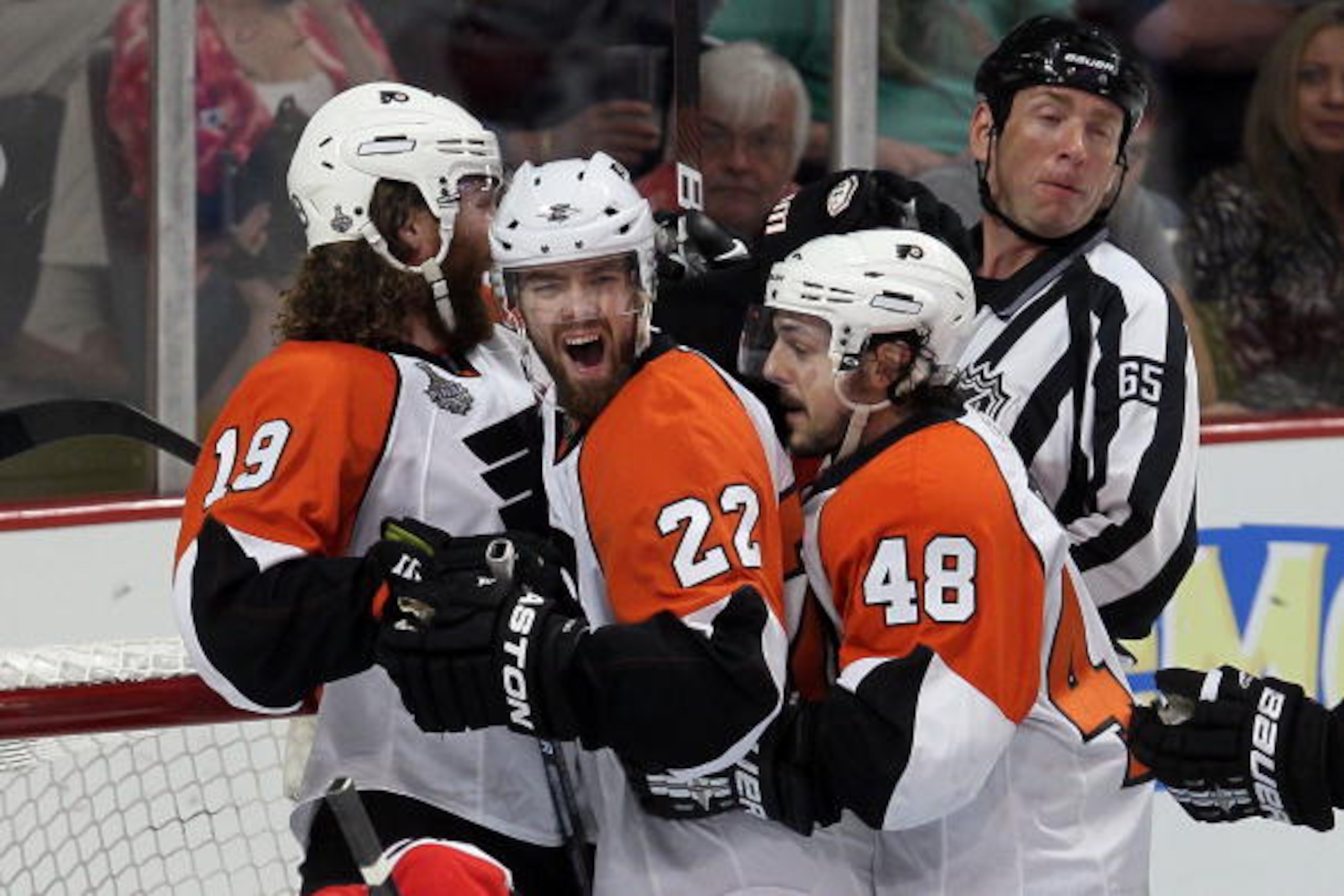 CHICAGO - MAY 29:  (C) Ville Leino #22 of the Philadelphia Flyers celebrates with teammates Scott Hartnell #19 and Danny Briere #48 after scoring a first period goal against the Chicago Blackhawks in Game One of the 2010 NHL Stanley Cup Final at the Unite