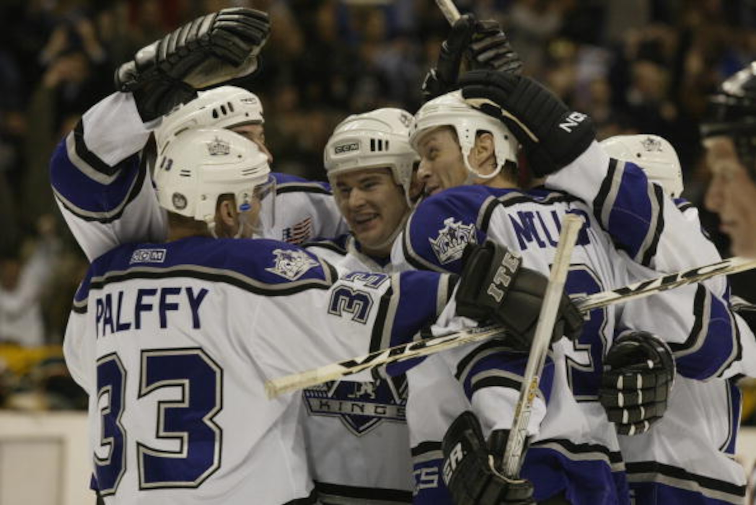 LOS ANGELES - JANUARY 24:  Adam Deadmarsh #28 (m) of the Los Angeles Kings celebrates with teammates Ziggy Palffy #33, Jason Allison (rear), Aaron Miller #3 and Lubomir Visnovsky (r) on a goal against the Minnesota Wild during the game on January 24, 2002