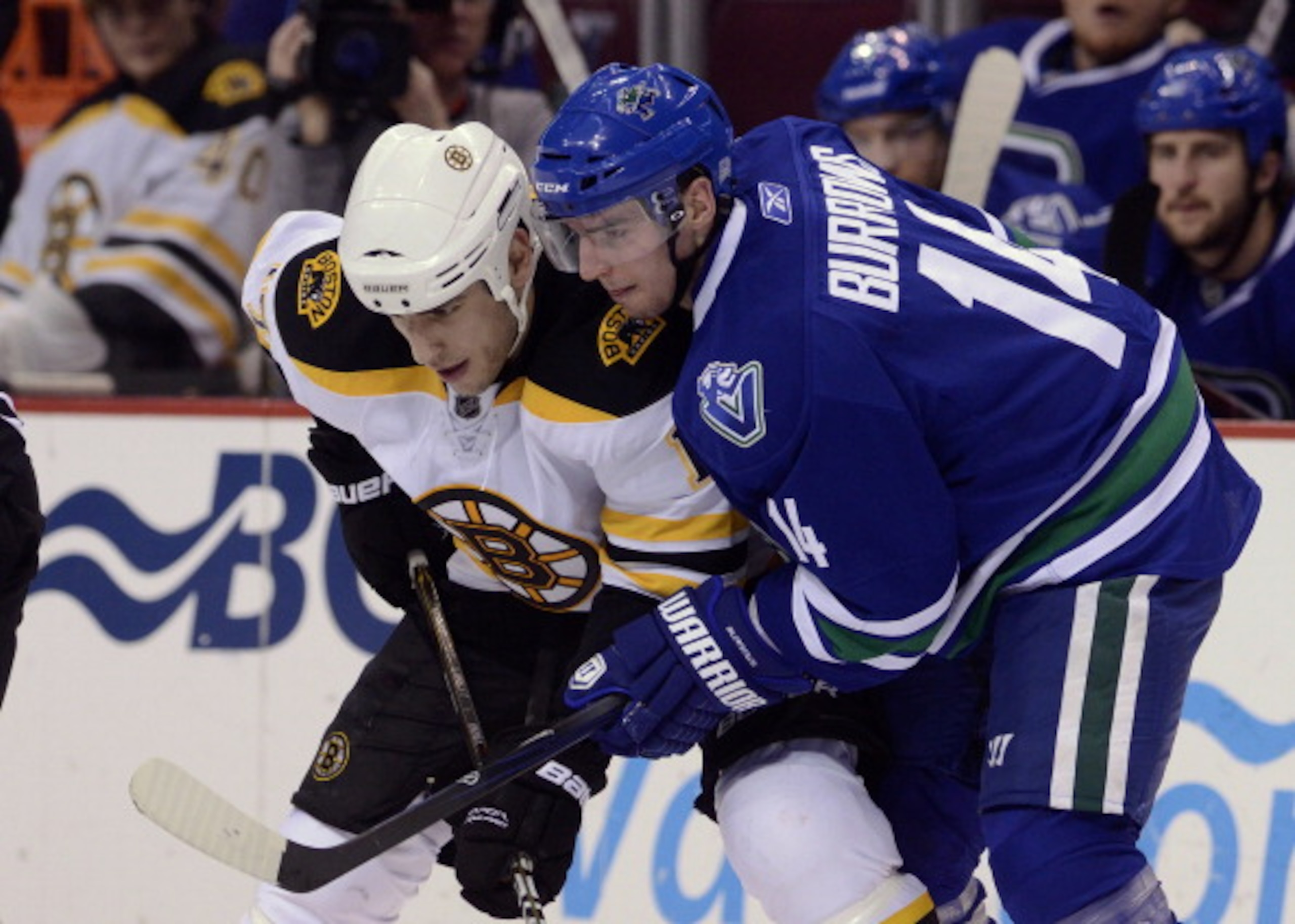 VANCOUVER, CANADA - FEBRUARY 26: Alexandre Burrows #14 of the Vancouver Canucks gets in close to Milan Lucic #17 of the Boston Bruins on a face-off during the third period in NHL action on February 26, 2011 at Rogers Arena in Vancouver, British Columbia,