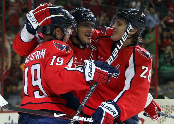 WASHINGTON DC, DC - SEPTEMBER 23:  Alex Ovechkin #8 of the Washington Capitals celebrates his second period goal against the Chicago Blackhawks with teammates Nicklas Backstrom #19 and Alexander Semin #28 during their preseason game on September 23, 2009