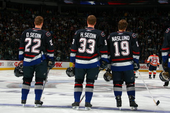VANCOUVER, BC - JANUARY 7:  Daniel Sedin #22, Henrik Sedin #33 and Markus Naslund #19 of the Vancouver Canucks stand for the National Anthem before the game against the Florida Panthers at General Motors Place on January 7, 2007 in Vancouver, British Colu