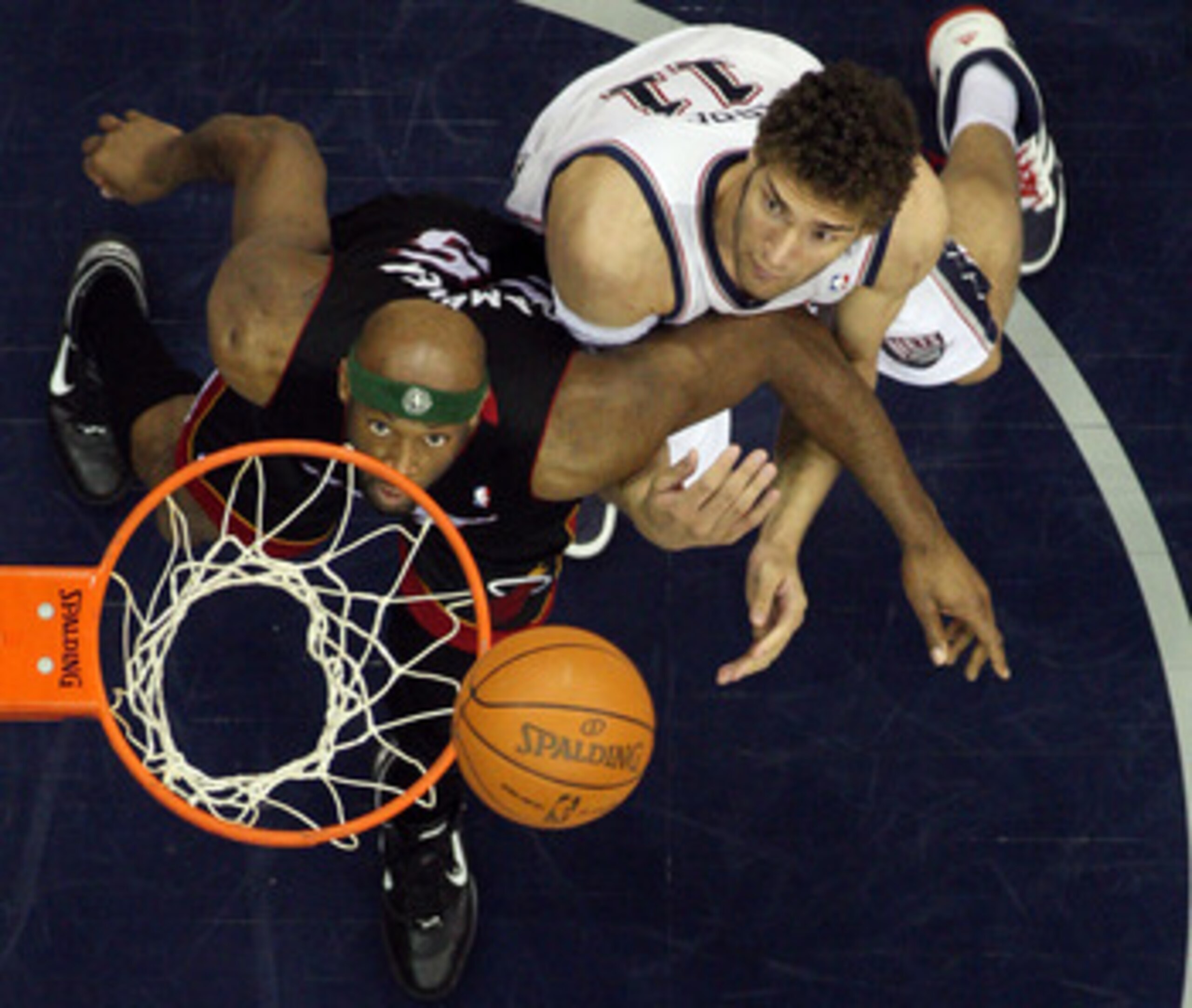 NEWARK, NJ - APRIL 03:  Eric Dampier #25 of the Miami Heat and Brook Lopez #11 of the New Jersey Nets battle for rebound at the Prudential Center on April 3, 2011 in Newark, New Jersey.The Heat defeated the Nets 108-94.NOTE TO USER: User expressly acknowl