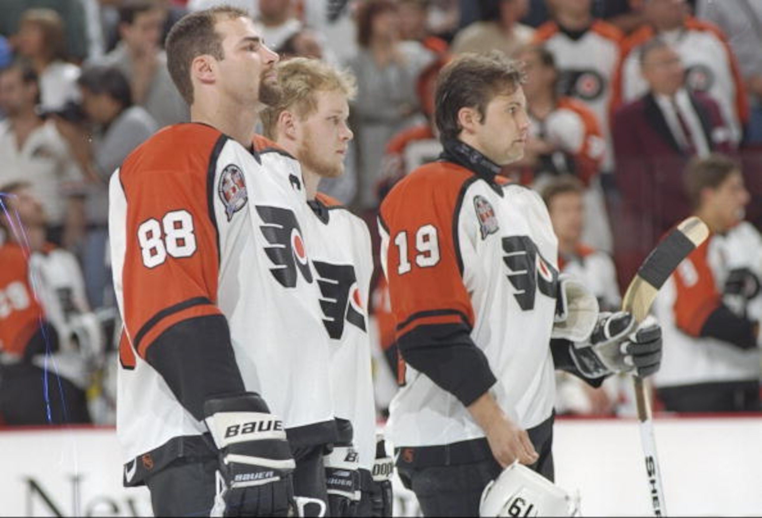 31 May 1997:  Philadelphia Flyers center Eric Lindros (left) and rightwinger Mikael Renberg (right) flank an unidentified teammate during Game 1 of the Stanley Cup Finals against the Detroit Red Wings at the CoreStates Center in Philadelphia, Pennsylvania