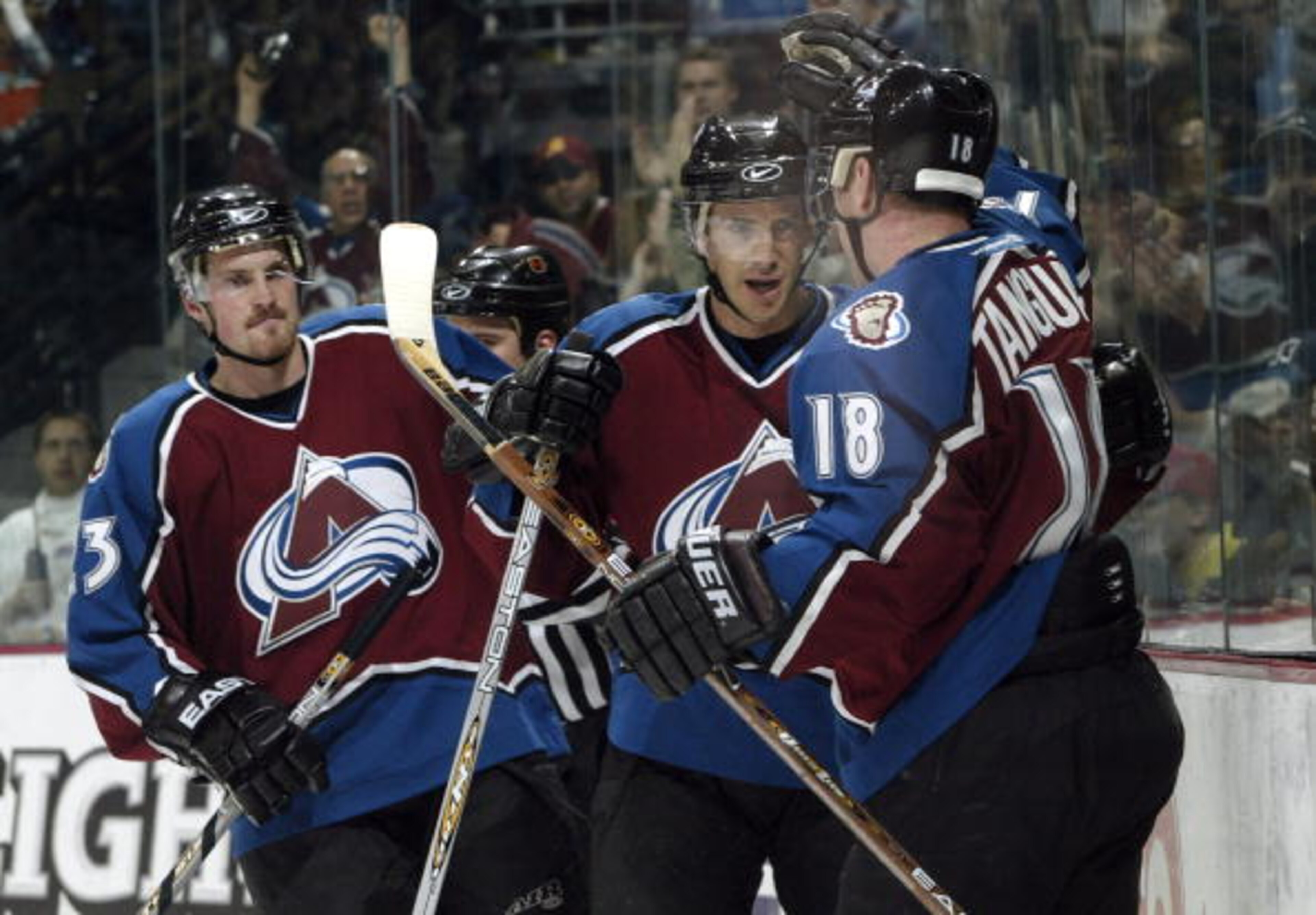 DENVER - NOVEMBER 20:  Joe Sakic #19 and Alex Tanguay #18 of the Colorado Avalanche celebrate after combining for a power play goal against the New York Rangers in the first period November 20, 2003 at the Pepsi Center in Denver, Colorado.  Milan Hejduk #