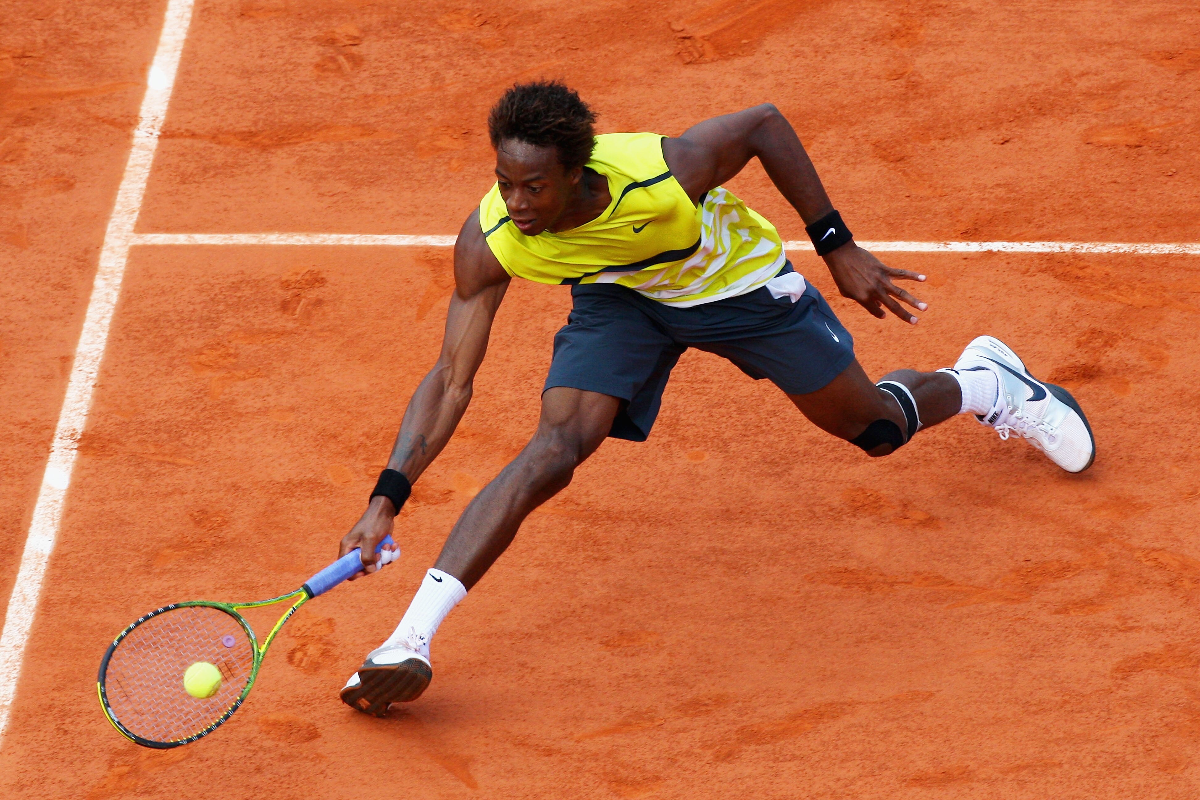 PARIS - JUNE 03:  Gael Monfils of France plays a forehand during the Men's Singles Quarter Final match against Roger Federer of Switzerland on day eleven of the French Open at Roland Garros on June 3, 2009 in Paris, France.  (Photo by Ryan Pierse/Getty Im