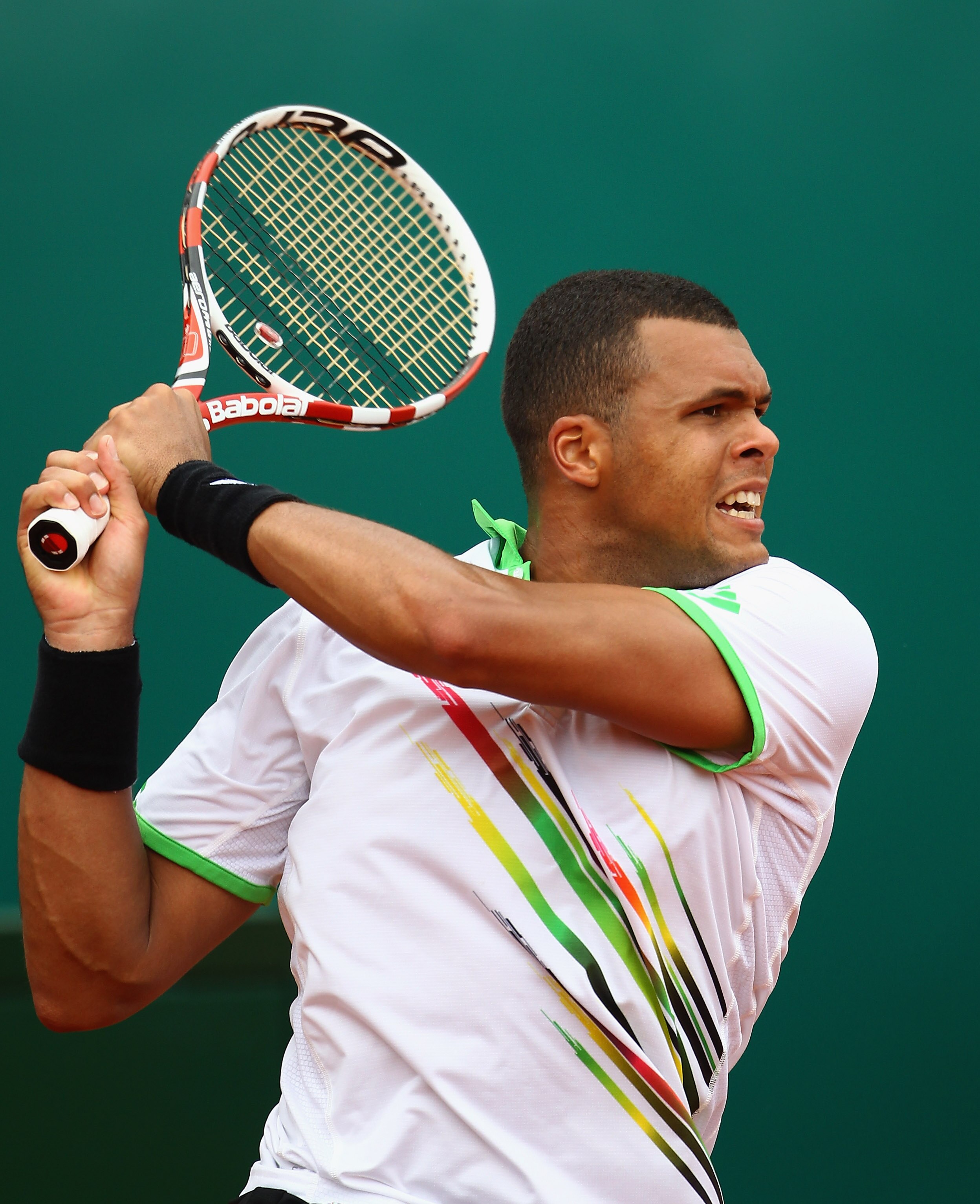 MONACO - APRIL 12:  Jo-Wilfried Tsonga of France plays a backhand in his match against Ivan Ljubicic of Croatia during Day Three of the ATP Masters Series Tennis at the Monte Carlo Country Club on April 12, 2011 in Monte Carlo, Monaco.  (Photo by Julian F
