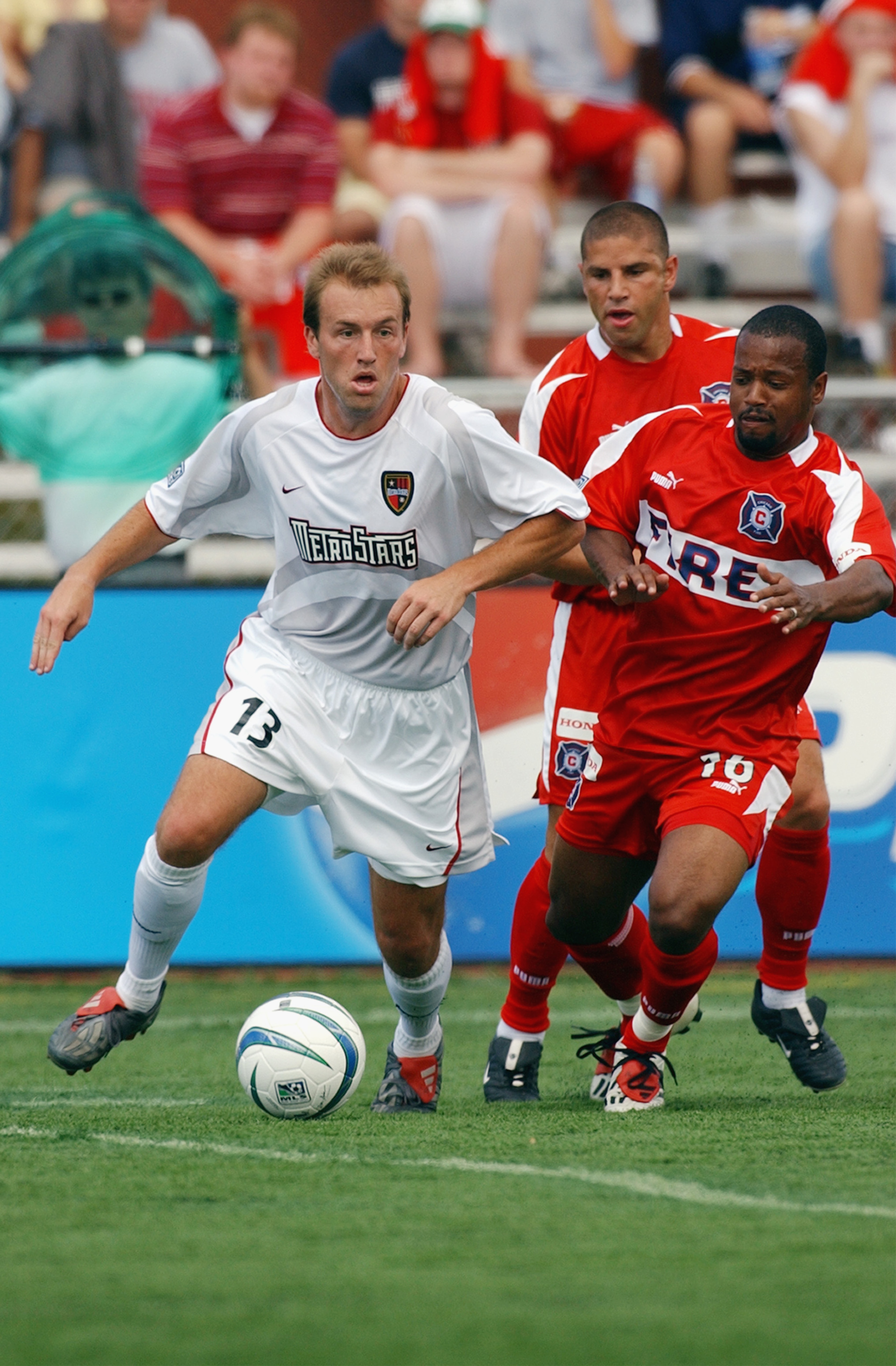NAPERVILLE, IL - JUNE 28: Andy Williams #16 of the Chicago Fire defends Clint Mathis #13 of the NY/NJ MetroStars during their MLS game on June 28, 2003 at Cardinal Stadium in Naperville, Illinois. The Fire defeated the MetroStars 2-1 in overtime. (Photo NAPERVILLE, IL - JUNE 28: Andy Williams #16 of the Chicago Fire defends Clint Mathis #13 of the NY/NJ MetroStars during their MLS game on June 28, 2003 at Cardinal Stadium in Naperville, Illinois. The Fire defeated the MetroStars 2-1 in overtime. (Photo