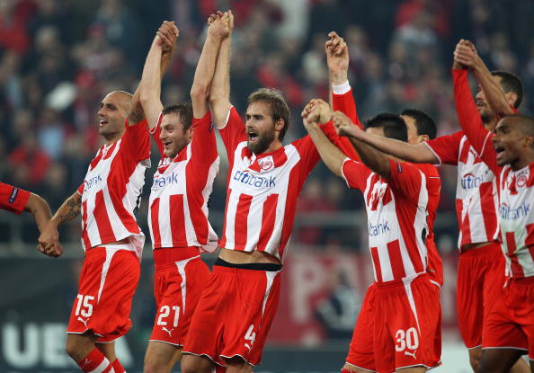 ATHENS, GREECE - DECEMBER 09:  Olympiakos players celebrate victory at the final whistle during the UEFA Champions League Group H match between Olympiakos and Arsenal at the Georgios Karaiskakis Stadium on December 9, 2009 in Athens, Greece.  (Photo by Ri