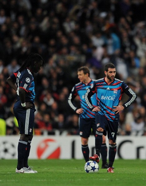 MADRID, SPAIN - MARCH 16:  Bafetimbi Gomis (L) and Lisandro (R) of Lyon stand dejected after conceding a goal during the UEFA Champions League round of 16 second leg match between Real Madrid and Lyon at Estadio Santiago Bernabeu on March 16, 2011 in Madr