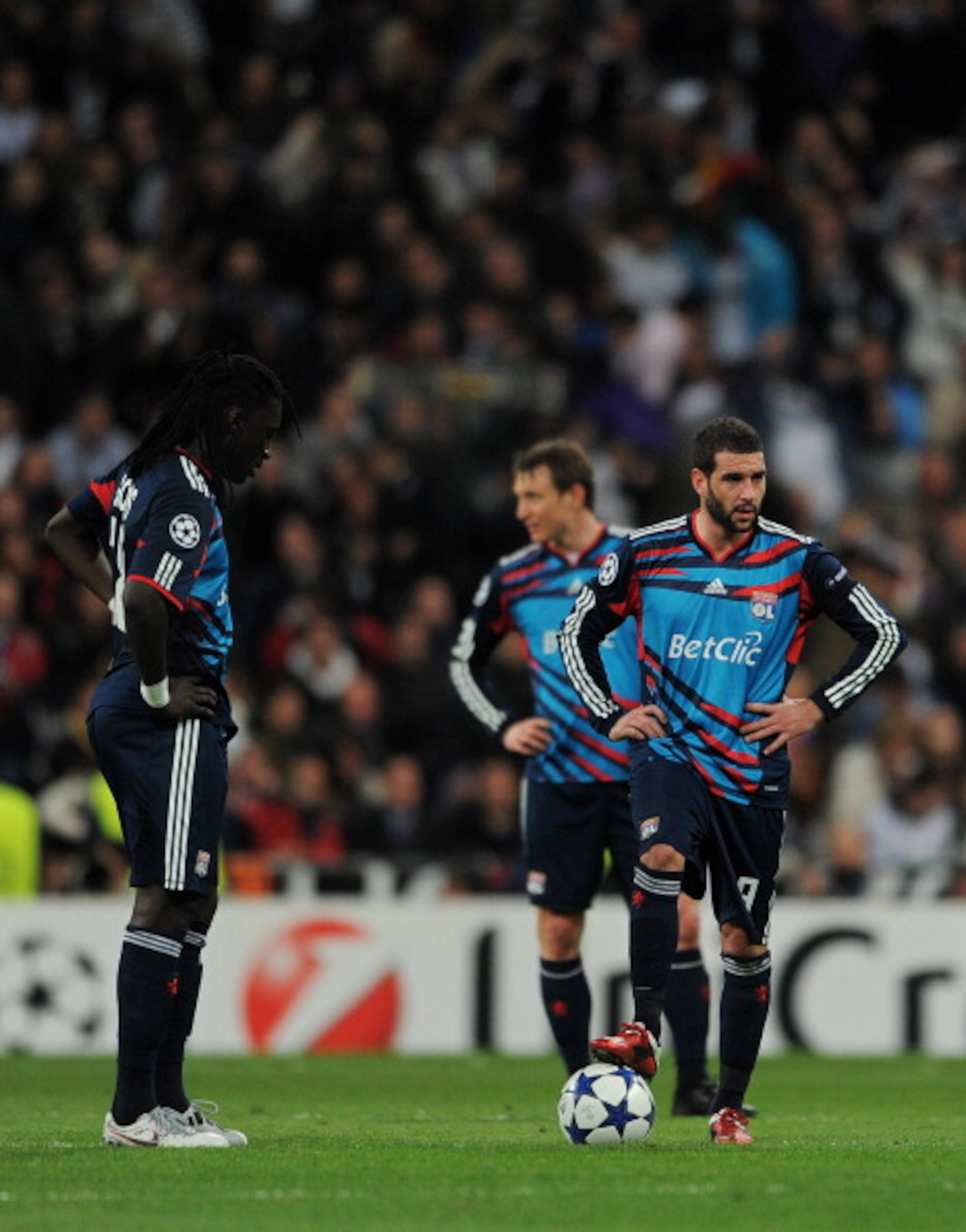 MADRID, SPAIN - MARCH 16: Bafetimbi Gomis (L) and Lisandro (R) of Lyon stand dejected after conceding a goal during the UEFA Champions League round of 16 second leg match between Real Madrid and Lyon at Estadio Santiago Bernabeu on March 16, 2011 in Madr MADRID, SPAIN - MARCH 16: Bafetimbi Gomis (L) and Lisandro (R) of Lyon stand dejected after conceding a goal during the UEFA Champions League round of 16 second leg match between Real Madrid and Lyon at Estadio Santiago Bernabeu on March 16, 2011 in Madr