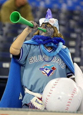 TORONTO - APRIL 6:  A fan of the Toronto Blue Jays cheers during batting practice as the Toronto Blue Jays  prepare to face the Detroit Tigers during their MLB opening day game at the Rogers Centre April 6, 2009 in Toronto, Ontario.(Photo By Dave Sandford