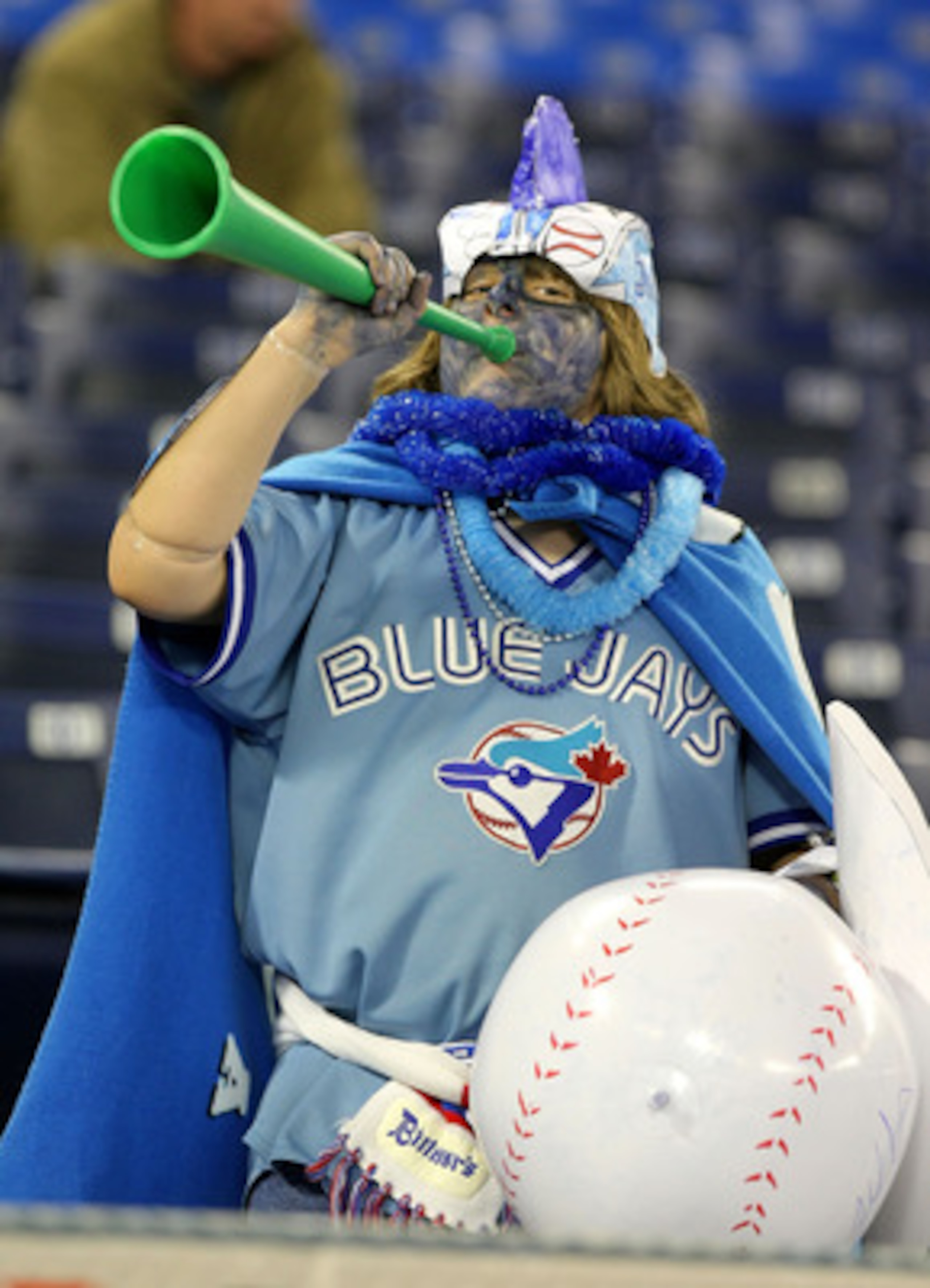 TORONTO - APRIL 6:  A fan of the Toronto Blue Jays cheers during batting practice as the Toronto Blue Jays  prepare to face the Detroit Tigers during their MLB opening day game at the Rogers Centre April 6, 2009 in Toronto, Ontario.(Photo By Dave Sandford
