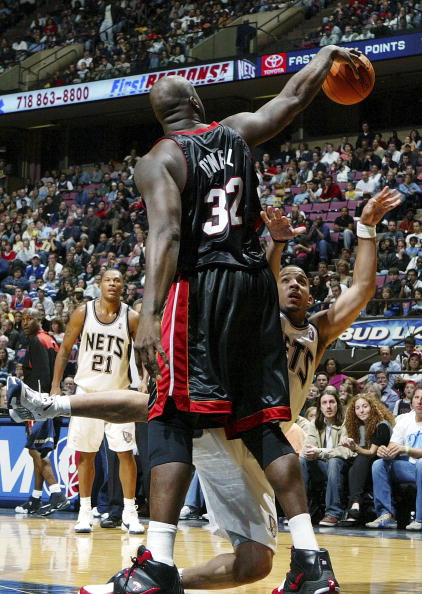 EAST RUTHERFORD, NJ - NOVEMBER 10: Shaquille O'Neal #32 of the Miami Heat commits a foul against Marcus Williams #1 of the New Jersey Nets during their game on November 10, 2006 at Continental Airlines Arena in East Rutherford, New Jersey. NOTE TO USER: U
