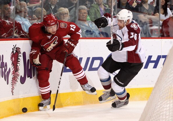 GLENDALE, AZ - APRIL 01:  Ray Whitney #13 of the Phoenix Coyotes attempts to control the puck under pressure from Jonas Holos #36 of the Colorado Avalanche during the NHL game at Jobing.com Arena on April 1, 2011 in Glendale, Arizona. The Avalanche defeat