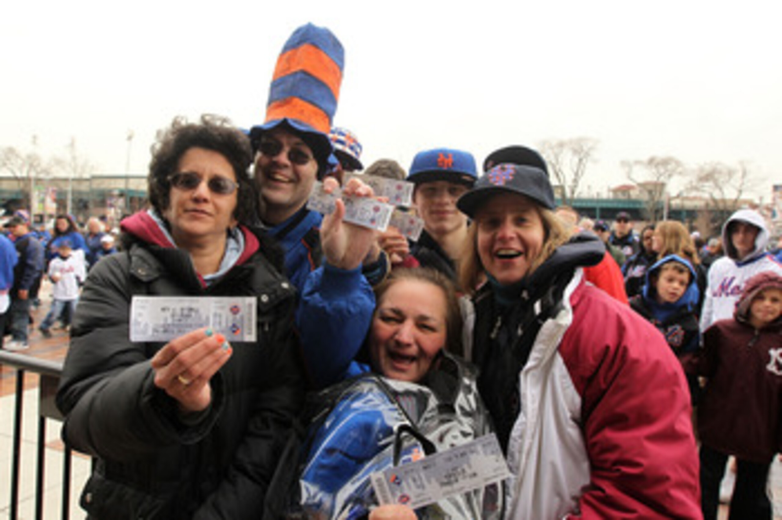 NEW YORK, NY - APRIL 08:  Fans of the New York Mets show off their tickets as they make their way into the stdium to watch them play against the Washington Nationals during the Mets' Home Opener at Citi Field on April 8, 2011 in the Flushing neighborhood