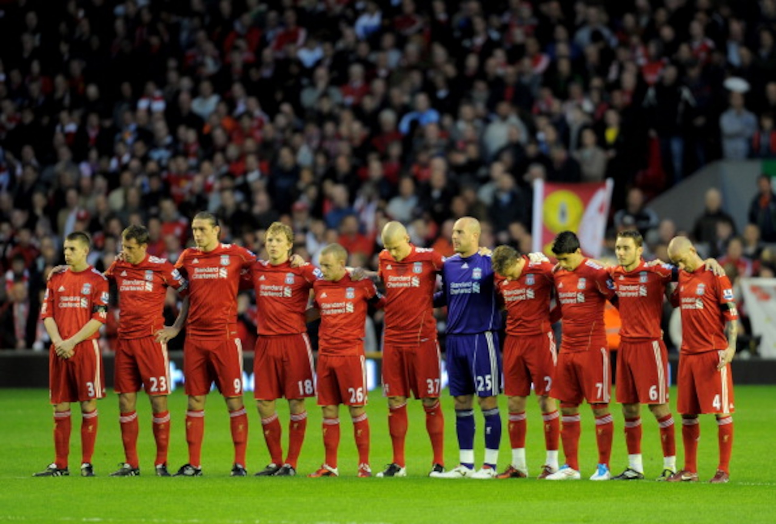 LIVERPOOL, ENGLAND - APRIL 11:  The Liverpool  players acknowledge a minutes silence in memory of the victims of the Hillsborough disaster prior to the Barclays Premier League match between Liverpool and Manchester City at Anfield on April 11, 2011 in Liv