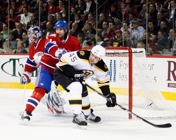 MONTREAL- APRIL 22:  Roman Hamrlik #44 of the Montreal Canadiens clears Mark Stuart #45 of the Boston Bruins from in front of Carey Price #31 during Game Four of the Eastern Conference Quarterfinals of the 2009 Stanley Cup Playoffs at the Bell Centre on A