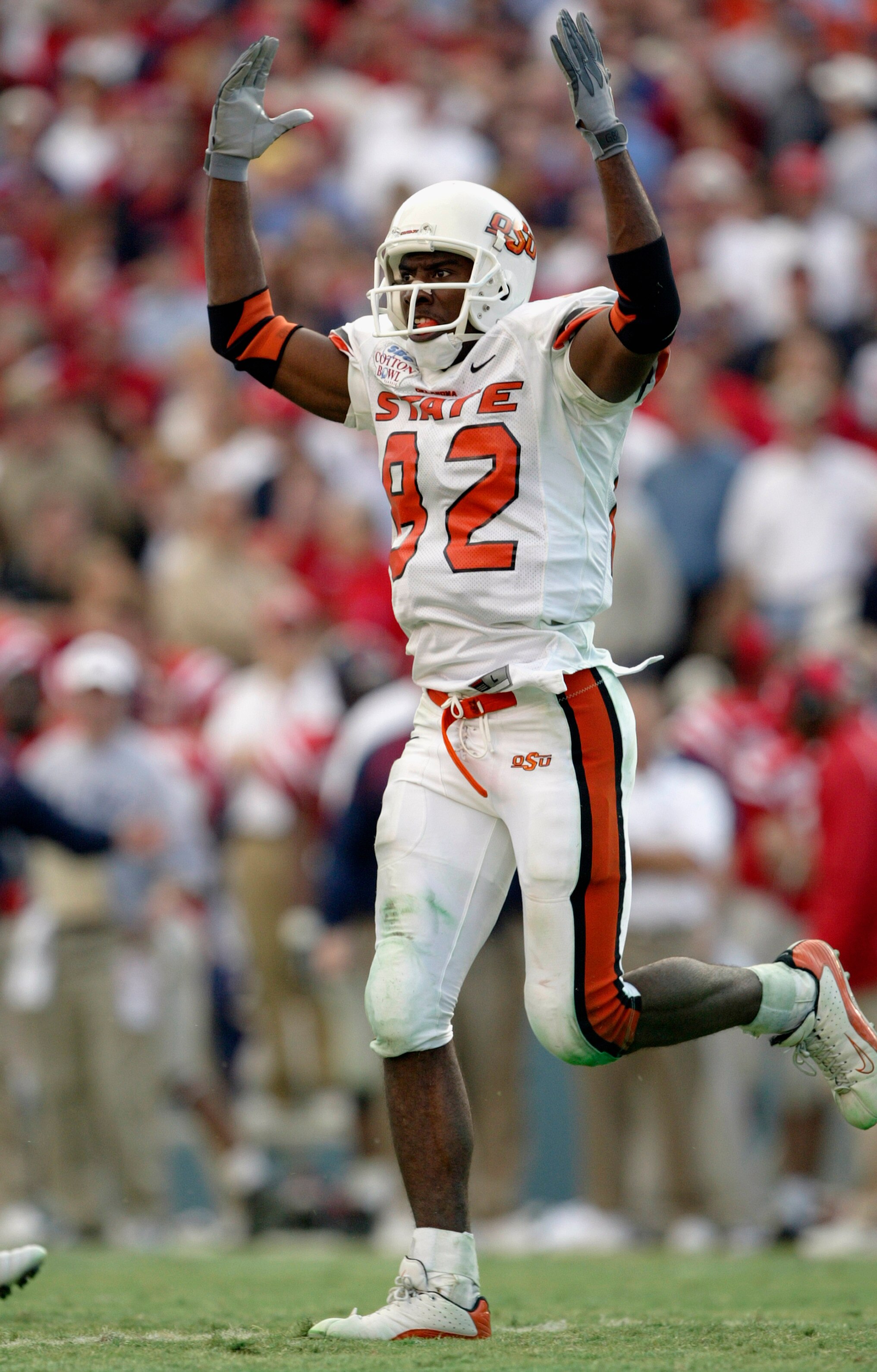DALLAS - JANUARY 2:  Wide receiver Rashaun Woods #82 of the Oklahoma State Cowboys celebrates during the SBC Cotton Bowl against the Mississippi Rebels  on January 2, 2004 at the Cotton Bowl in Dallas, Texas.  'Ole Miss defeated Oklahoma State 31-28.  (Ph