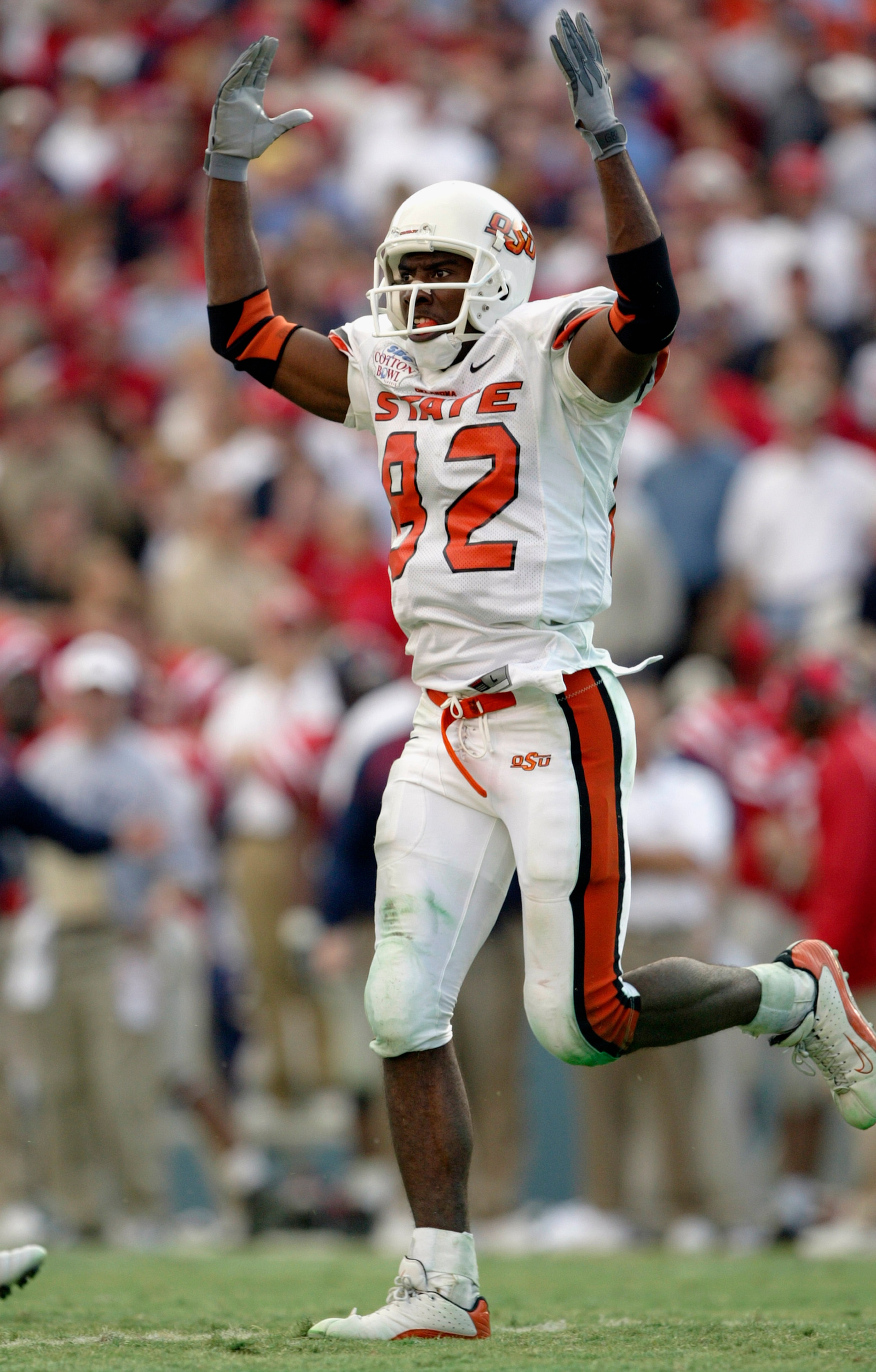 DALLAS - JANUARY 2:  Wide receiver Rashaun Woods #82 of the Oklahoma State Cowboys celebrates during the SBC Cotton Bowl against the Mississippi Rebels  on January 2, 2004 at the Cotton Bowl in Dallas, Texas.  'Ole Miss defeated Oklahoma State 31-28.  (Ph