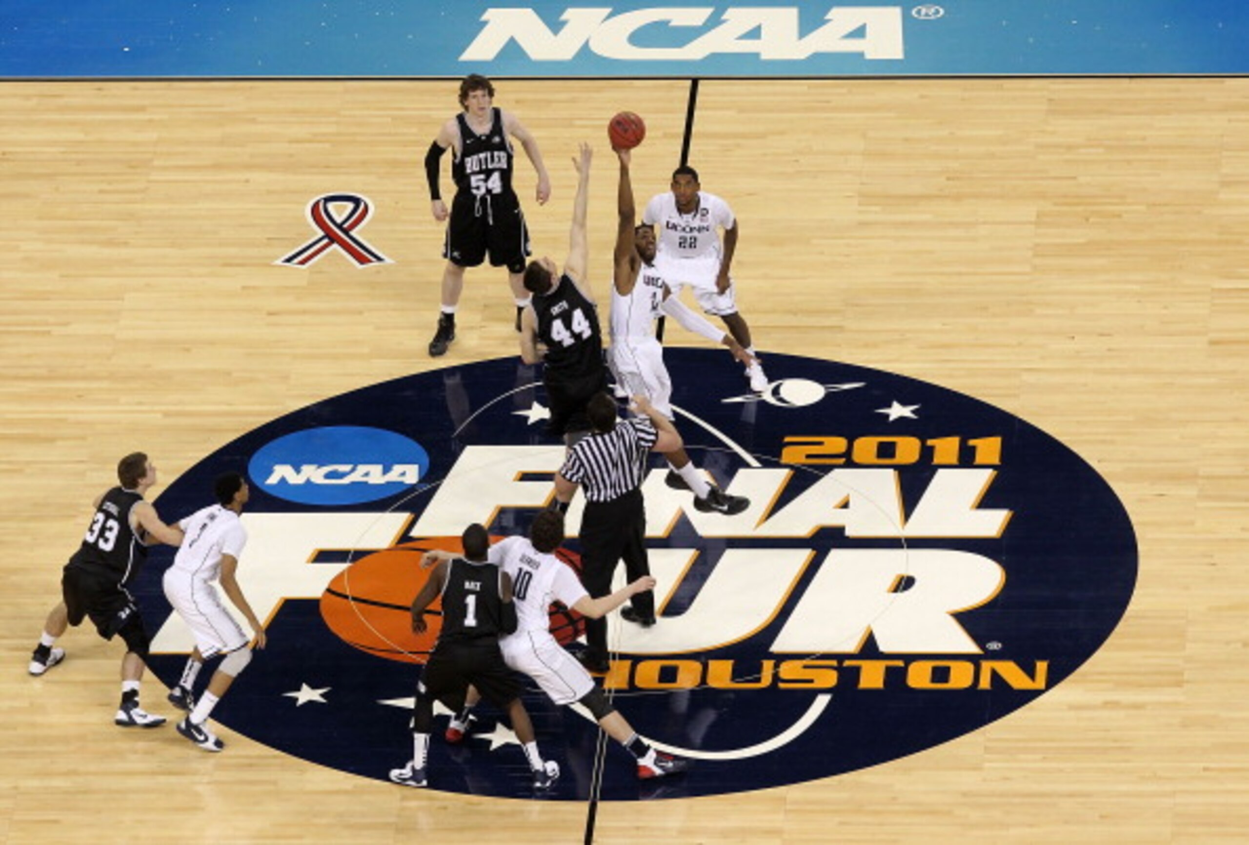 HOUSTON, TX - APRIL 04:  Andrew Smith #44 of the Butler Bulldogs tips the ball off against Alex Oriakhi #34 of the Connecticut Huskies to start the National Championship Game of the 2011 NCAA Division I Men's Basketball Tournament at Reliant Stadium on Ap