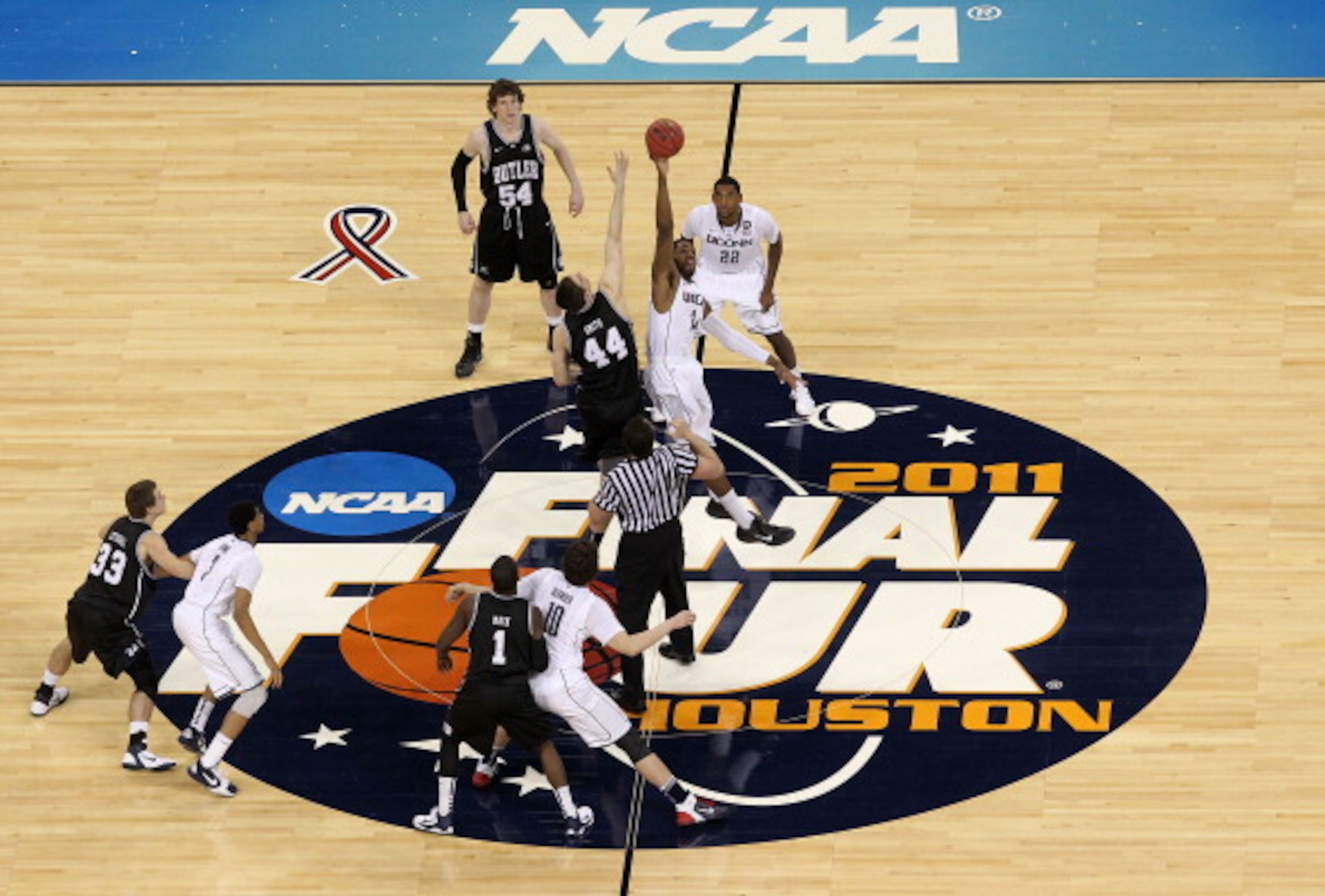 HOUSTON, TX - APRIL 04:  Andrew Smith #44 of the Butler Bulldogs tips the ball off against Alex Oriakhi #34 of the Connecticut Huskies to start the National Championship Game of the 2011 NCAA Division I Men's Basketball Tournament at Reliant Stadium on Ap