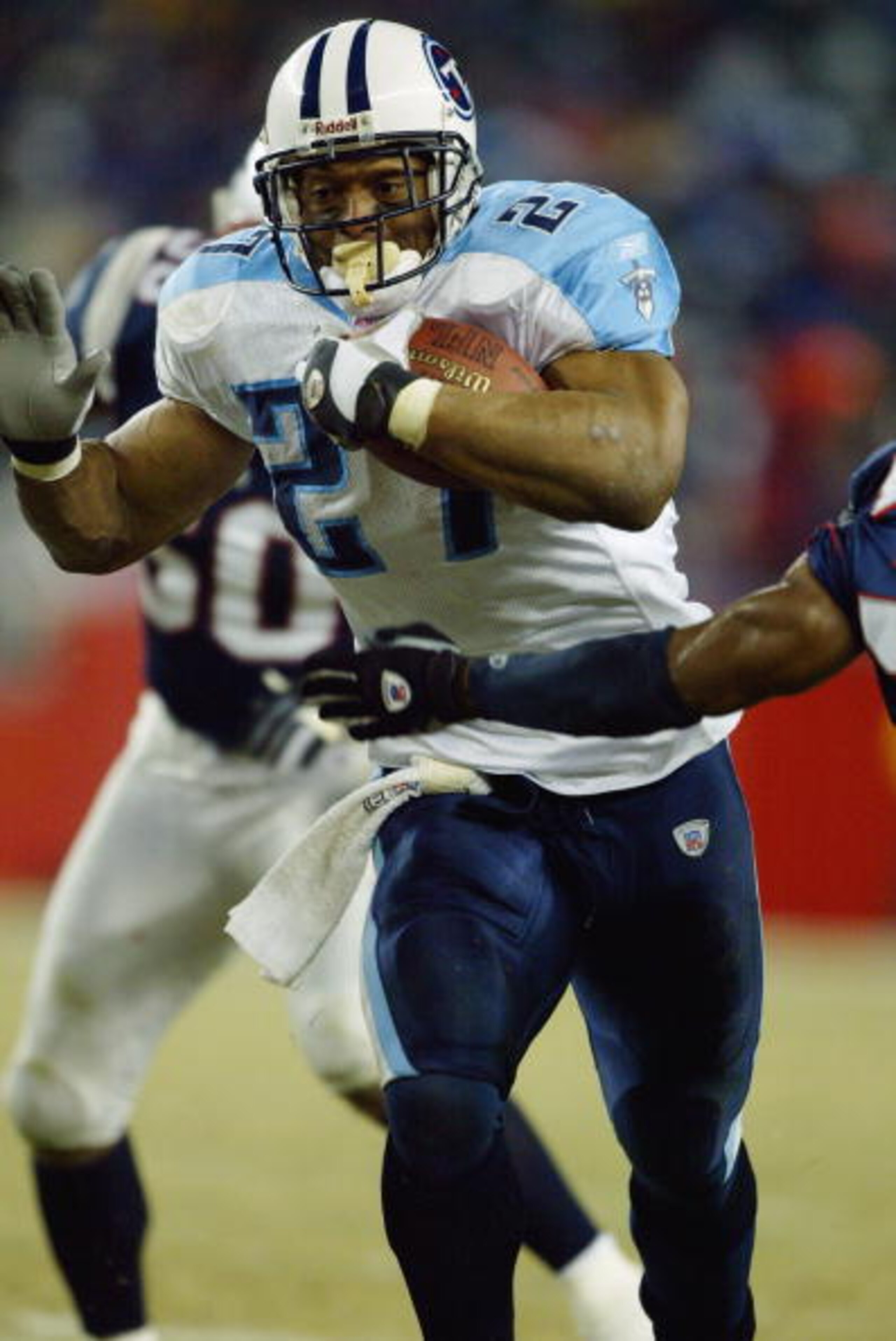 FOXBORO, MA - JANUARY 10:  Running back Eddie George #27 of the Tennessee Titans carries the football against the New England Patriots in the AFC divisional playoffs on January 10, 2004 at Gillette Stadium in Foxboro, Massachusetts. The Patriots won 17-14