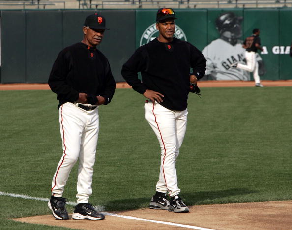 SAN FRANCISCO - APRIL 6:  Moises Alou #18 (R) and his father, manager Felipe Alou of the San Francisco Giants, talk during batting practice before the game against the Los Angeles Dodgers at SBC Park on April 6, 2005 in San Francisco, California.  (Photo