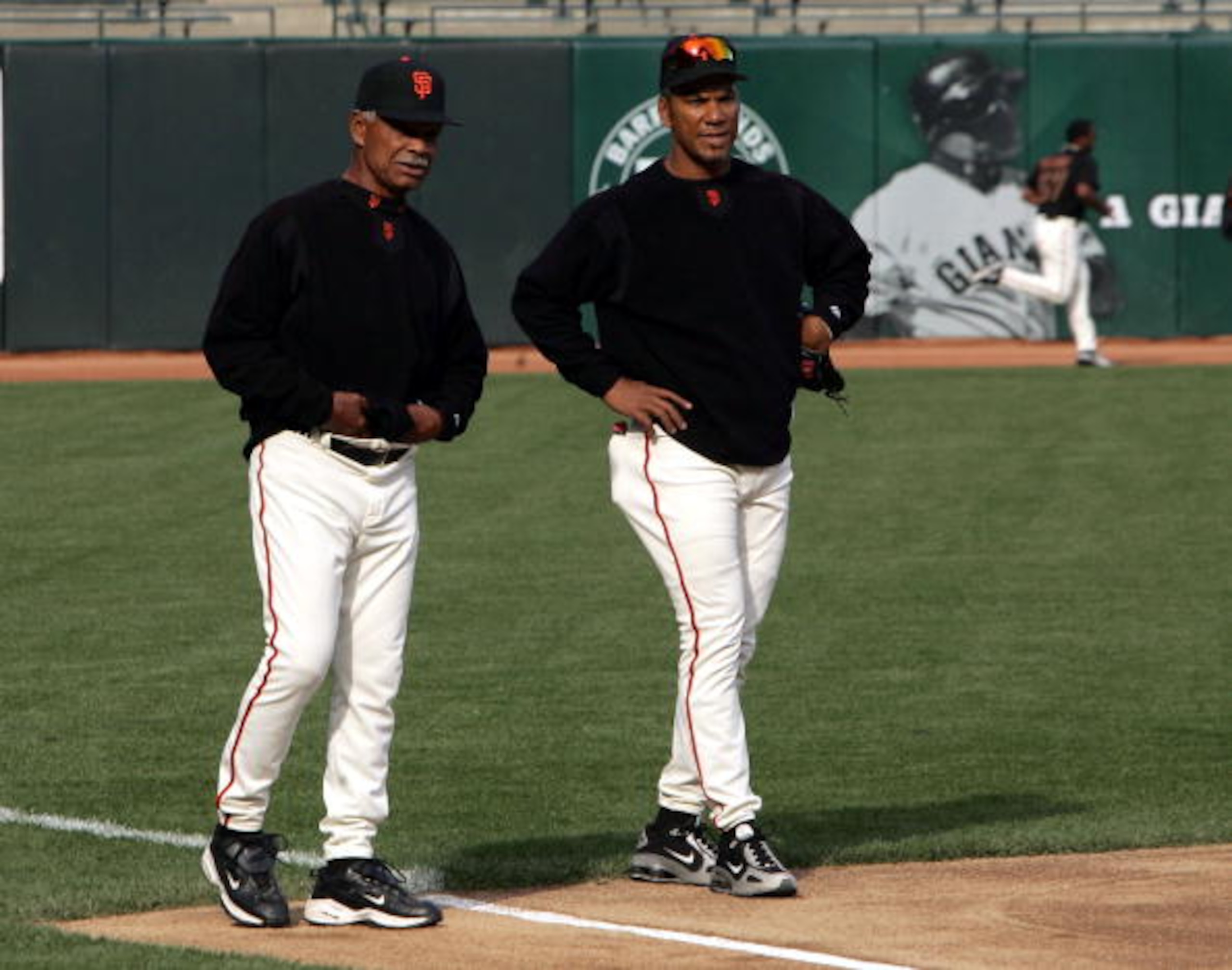 SAN FRANCISCO - APRIL 6:  Moises Alou #18 (R) and his father, manager Felipe Alou of the San Francisco Giants, talk during batting practice before the game against the Los Angeles Dodgers at SBC Park on April 6, 2005 in San Francisco, California.  (Photo