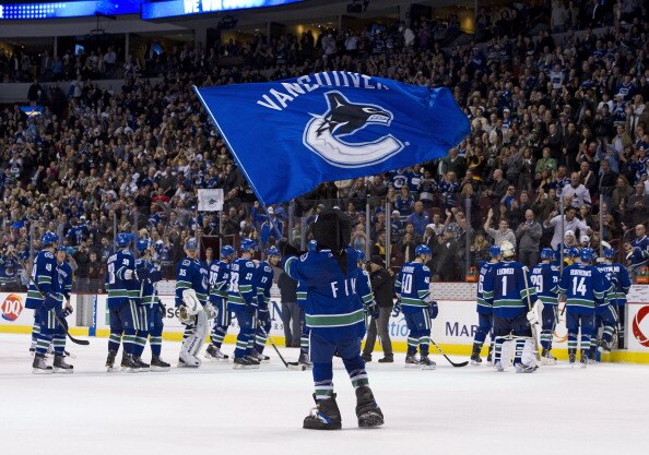VANCOUVER, CANADA - MARCH 31: Vancouver Canucks mascot Fin waves a team flag after the Vancouver Canucks defeated the Los Angeles Kings in NHL action on March 31, 2011 at Rogers Arena in Vancouver, BC, Canada.  (Photo by Rich Lam/Getty Images)