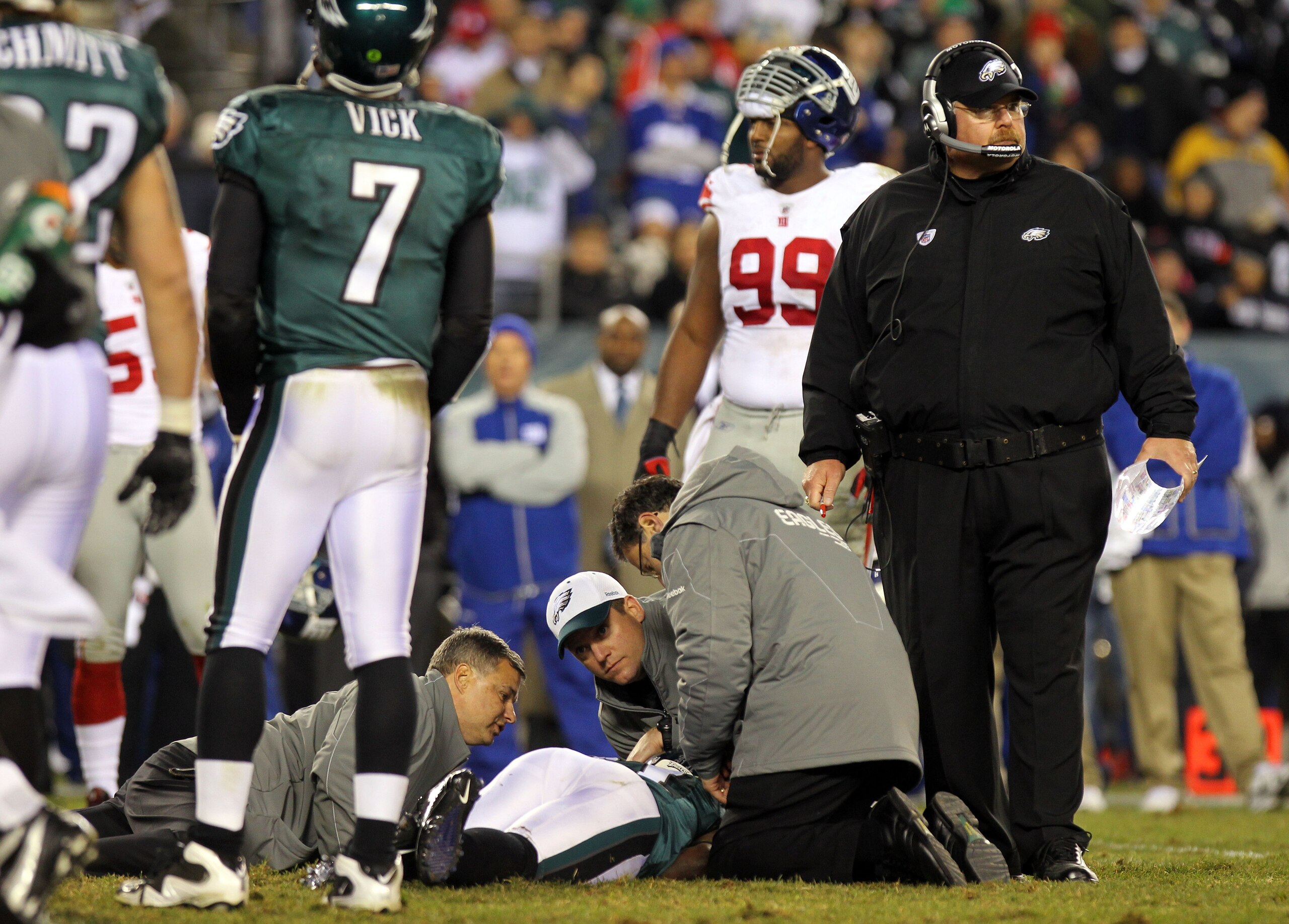 PHILADELPHIA - NOVEMBER 21: Ellis Hobbs #31 of the Philadelphia Eagles is tended to after getting injured on a kickoff returns against the New York Giants as head coach Andy Reid (R) looks on at Lincoln Financial Field on November 21, 2010 in Philadelphia