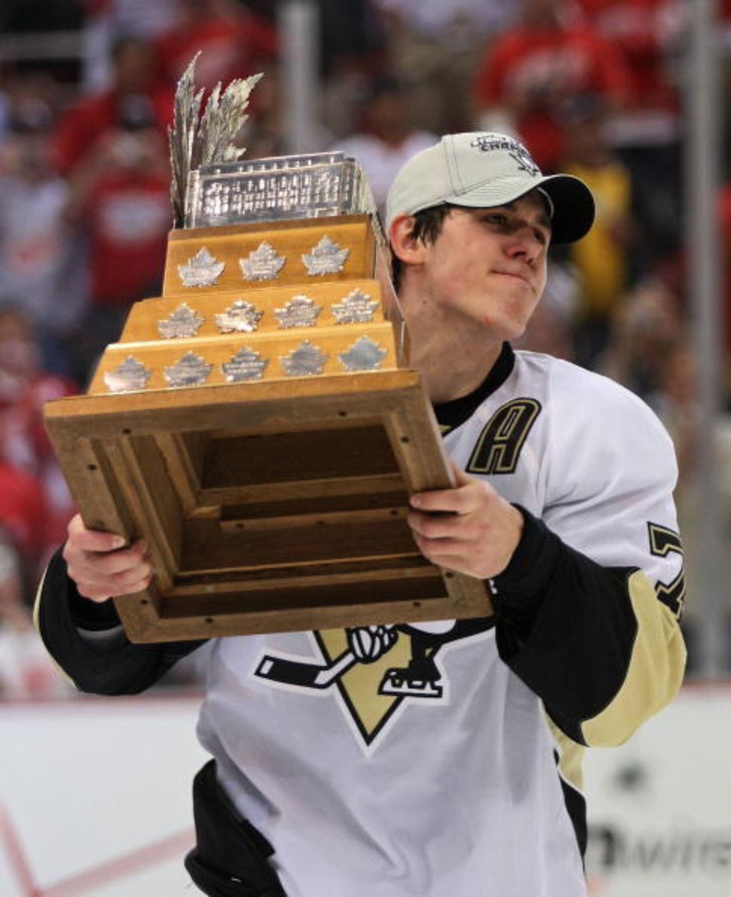 DETROIT - JUNE 12:  Evgeni Malkin #71 of the Pittsburgh Penguins holds the Conn Smythe Trophy following the Penguins victory over the Detroit Red Wings in Game Seven of the 2009 NHL Stanley Cup Finals at Joe Louis Arena on June 12, 2009 in Detroit, Michig