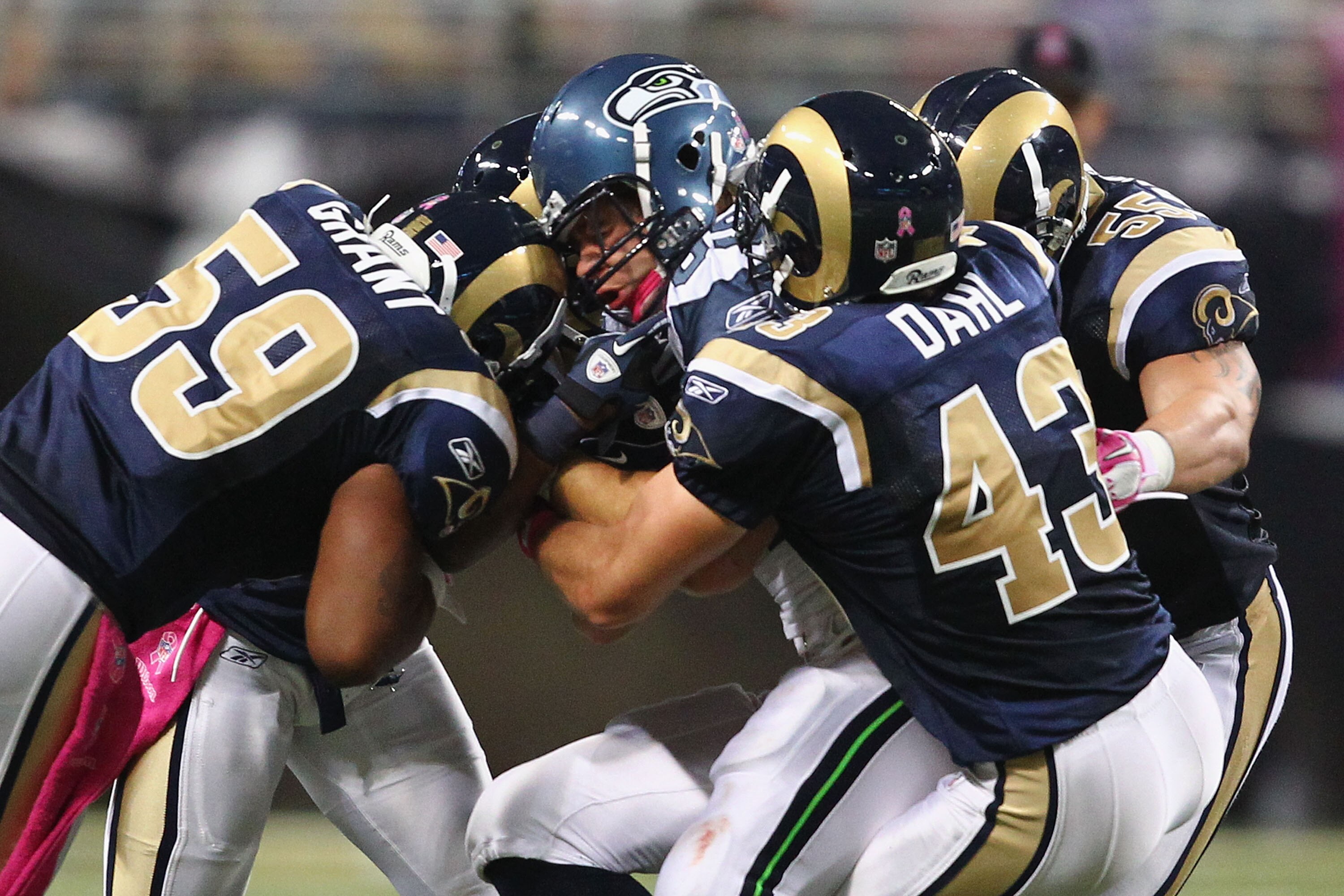 ST. LOUIS - OCTOBER 3: Anthony McCoy #85 of the Seattle Seahawks is stopped by Larry Grant #59, Craig Dahl #43 and James Laurinaitis #55 all of the St. Louis Rams at the Edward Jones Dome on October 3, 2010 in St. Louis, Missouri.  The Rams beat the Seaha