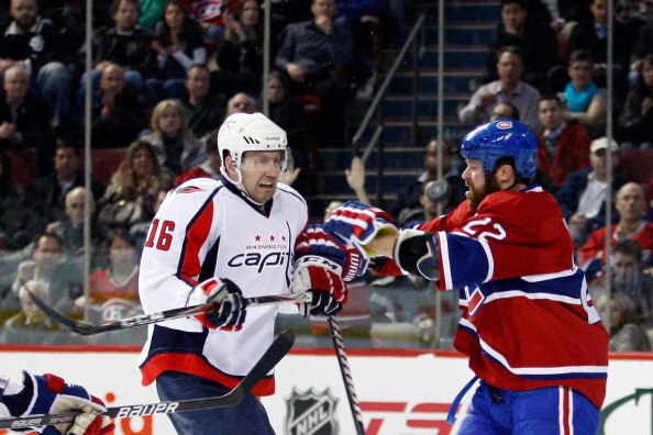 MONTREAL, CANADA - MARCH 15:  Eric Fehr #16 of the Washington Capitals and Paul Mara #22 of the Montreal Canadiens battle for a loose puck during the NHL game at the Bell Centre on March 15, 2011 in Montreal, Quebec, Canada.  The Capitals defeated the Can
