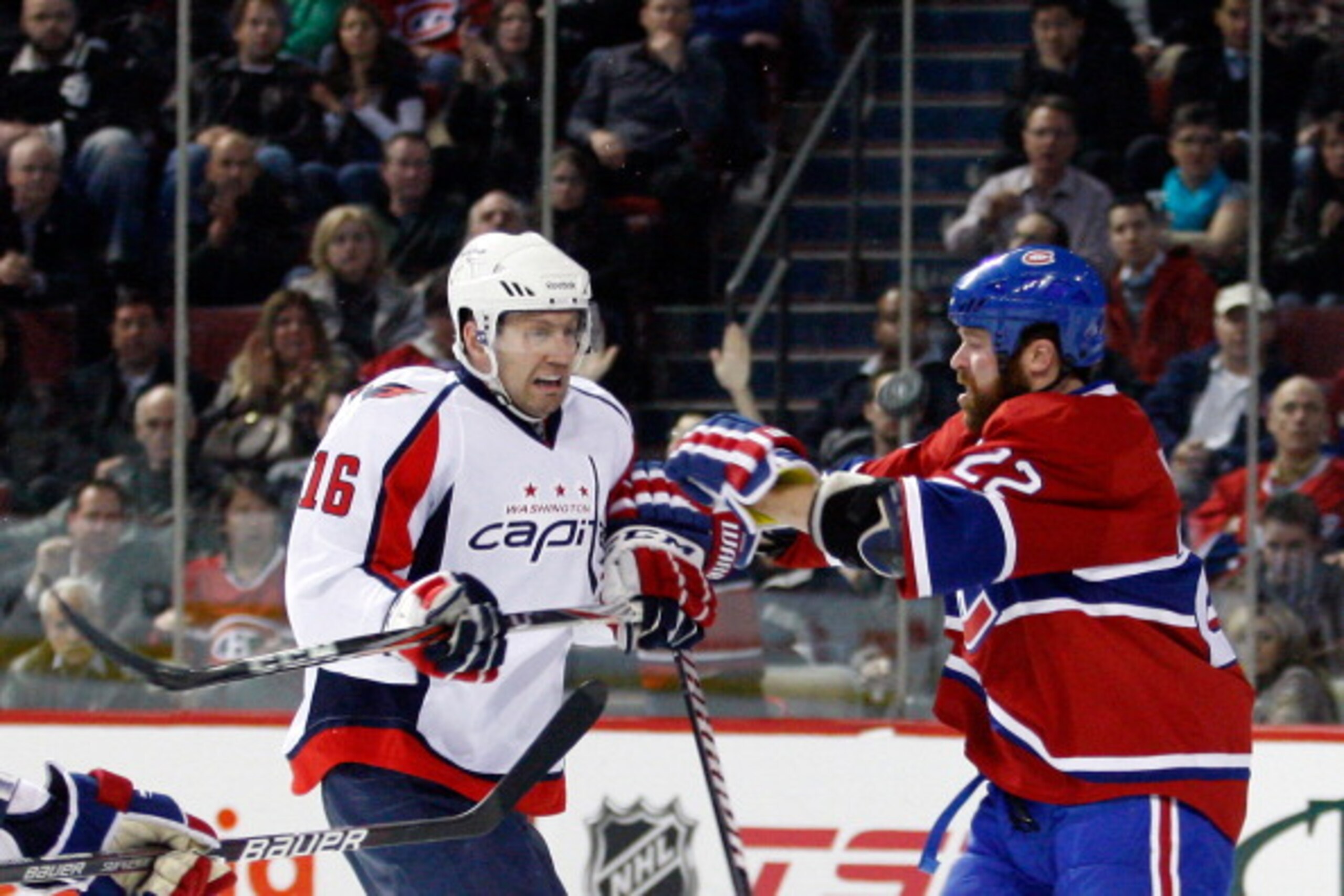 MONTREAL, CANADA - MARCH 15:  Eric Fehr #16 of the Washington Capitals and Paul Mara #22 of the Montreal Canadiens battle for a loose puck during the NHL game at the Bell Centre on March 15, 2011 in Montreal, Quebec, Canada.  The Capitals defeated the Can